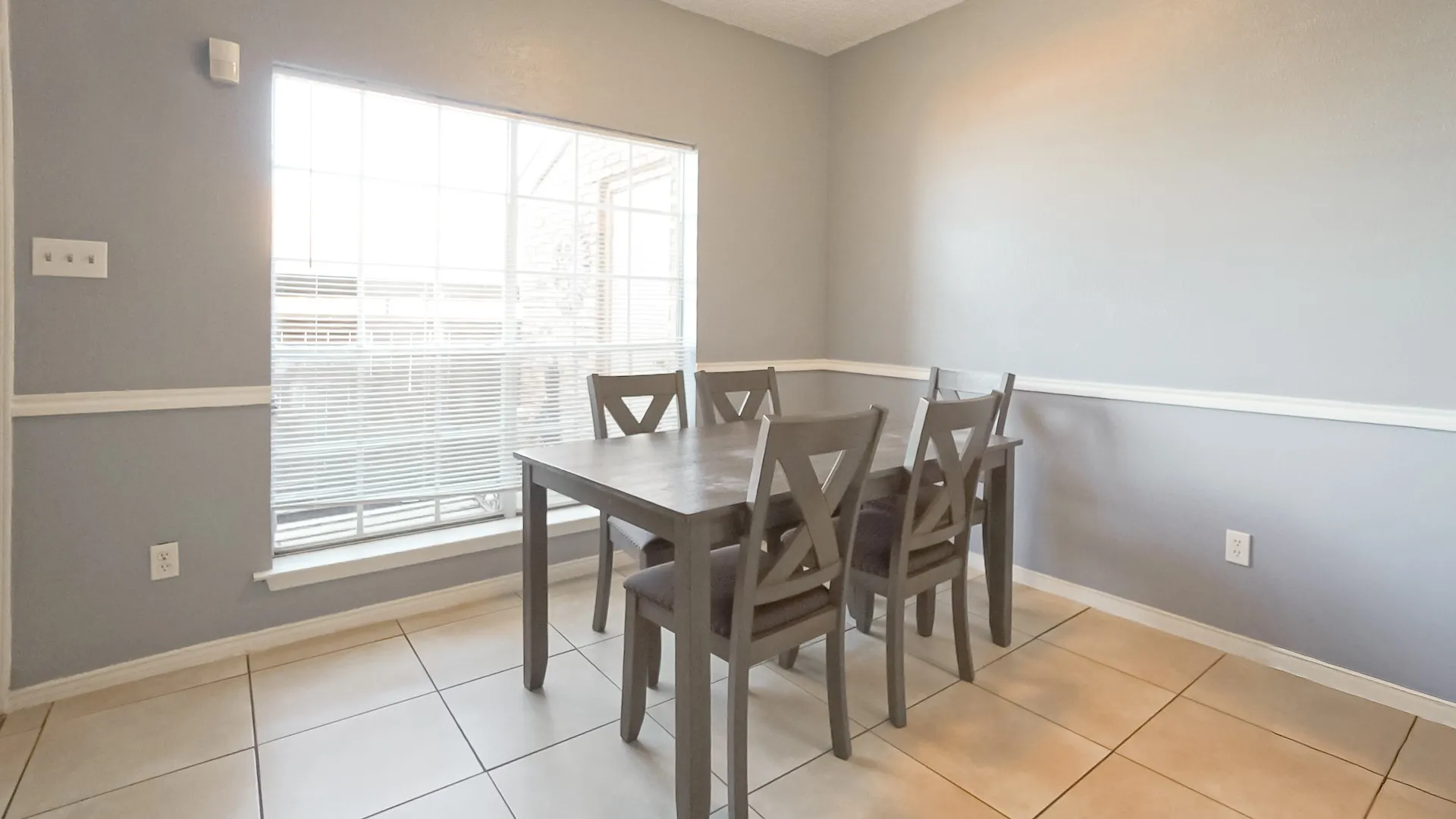 Dining area featuring baseboards and light tile patterned floors