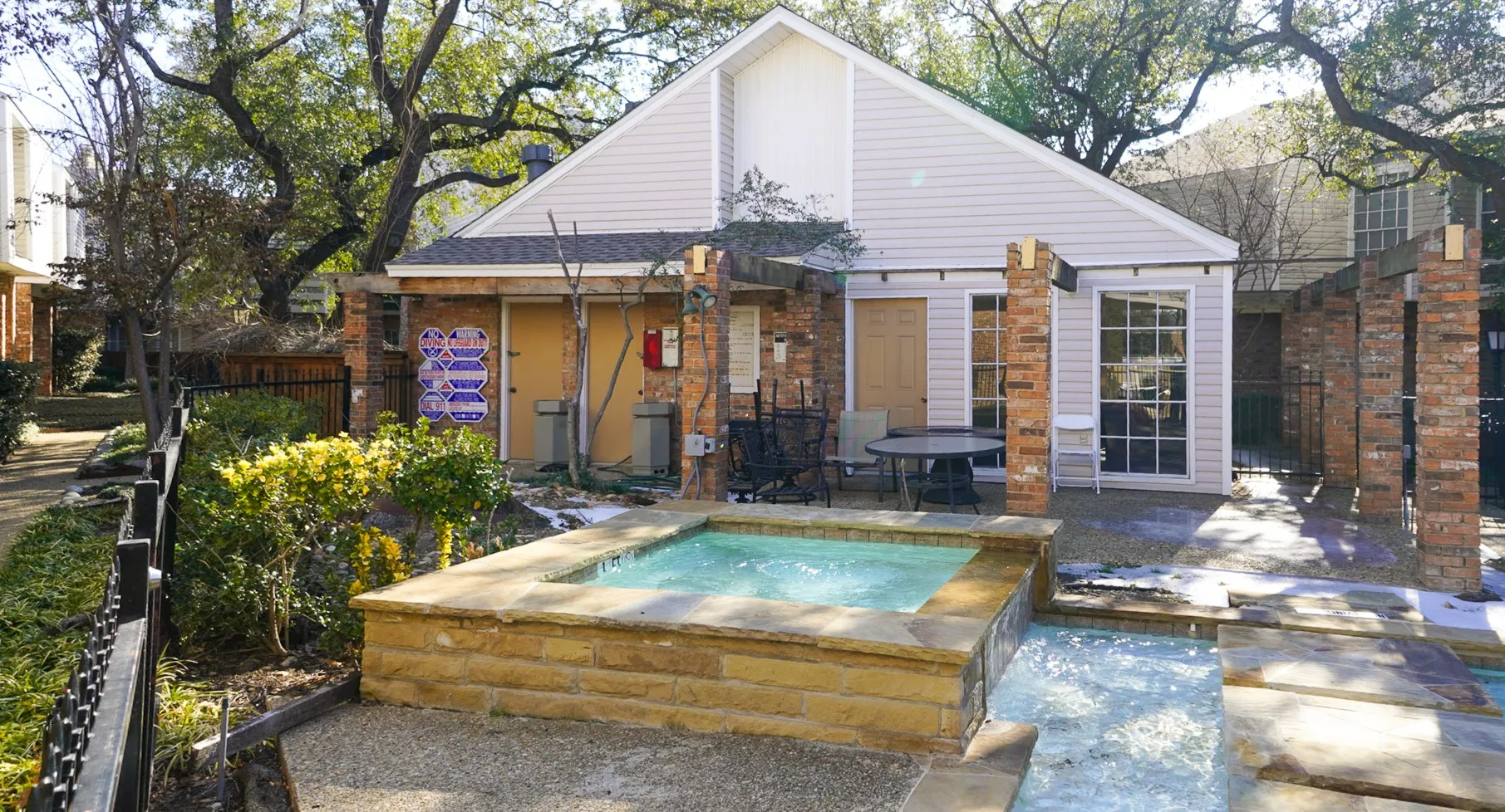 Clubhouse featuring a patio area and an in-ground hot tub