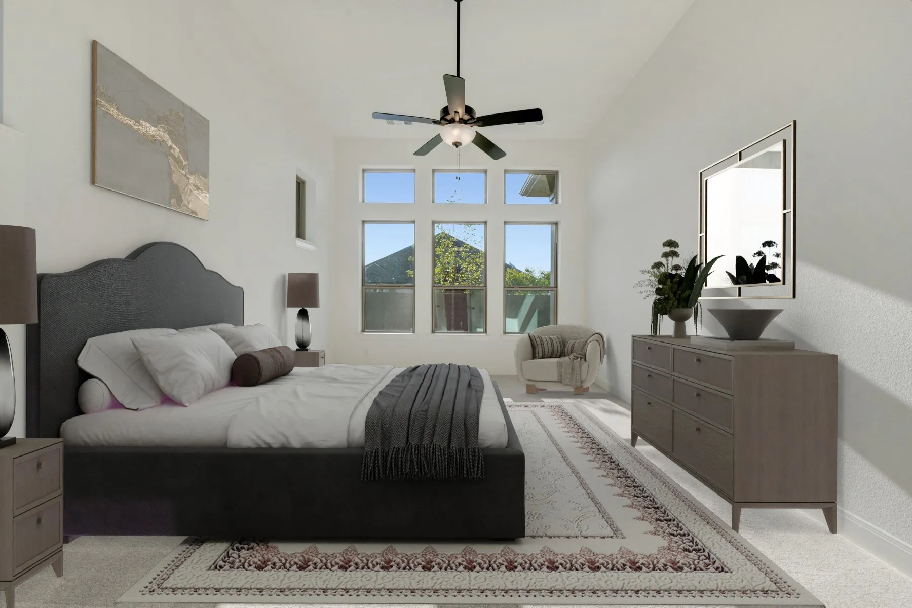 Spacious room featuring vaulted ceilings, a contemporary ceiling fan, and multiple windows providing ample natural light