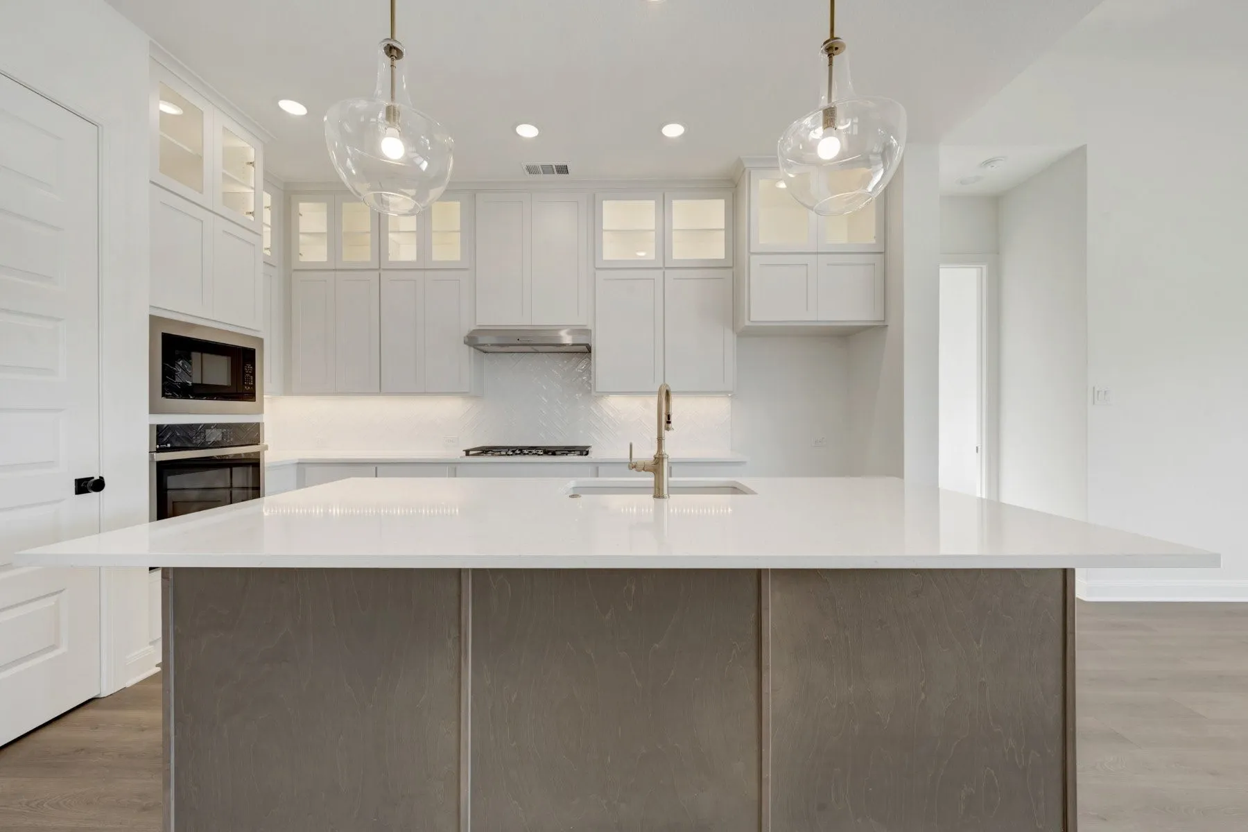 Kitchen island featuring a light-toned countertop and wood-finish paneling