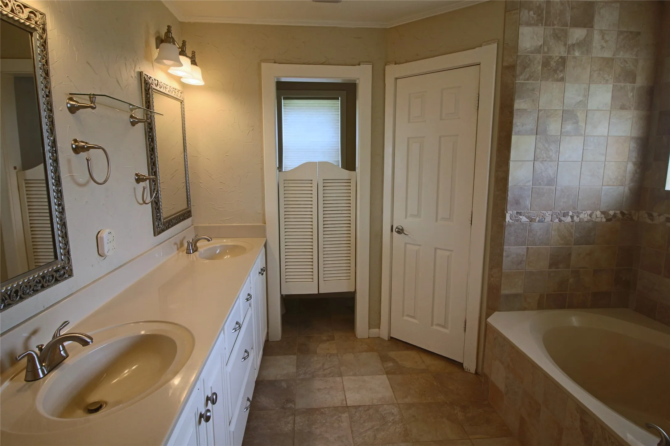 Master bath double vanity, with walk in closets and garden tub.
