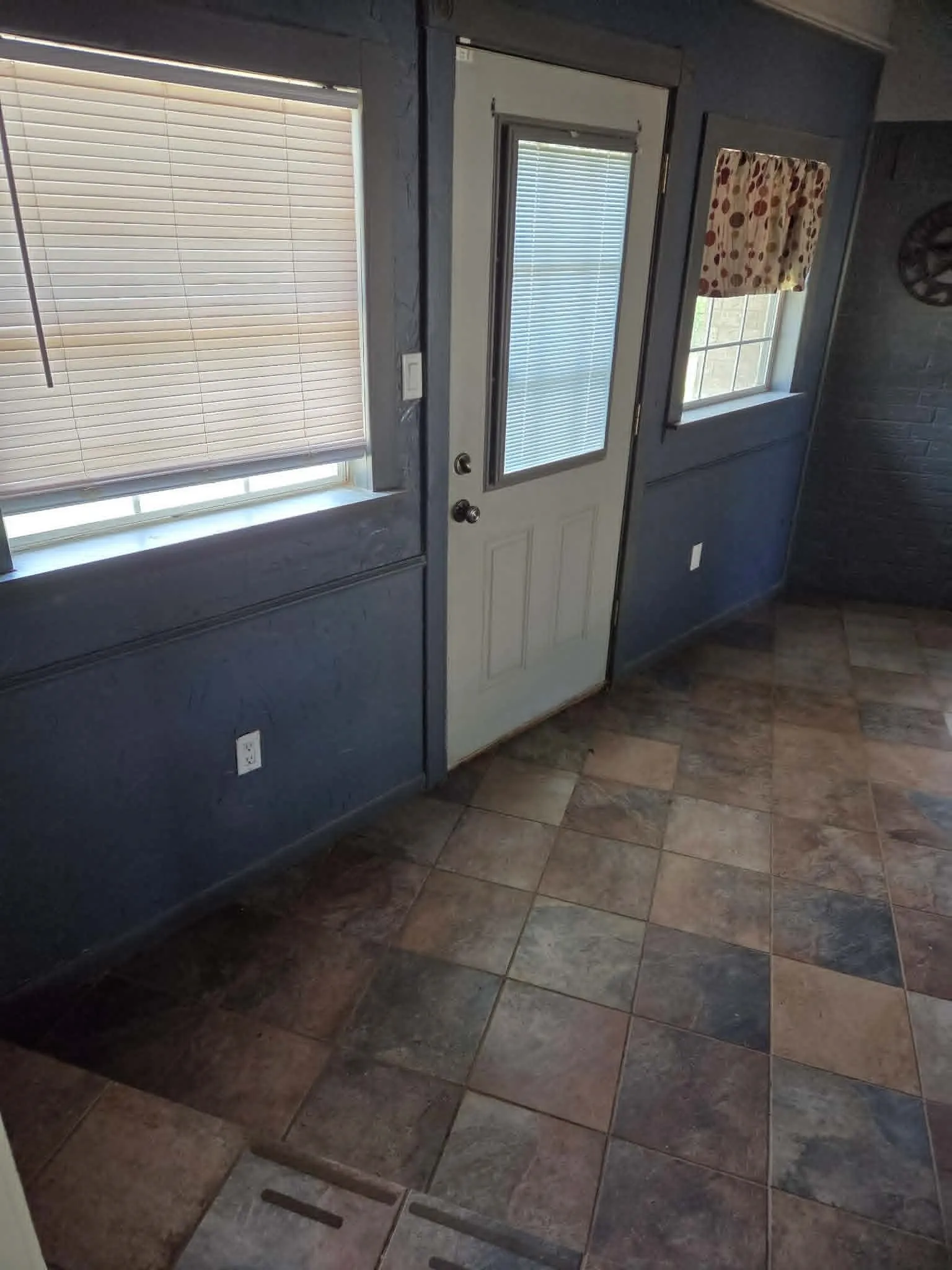 Entry way between the kitchen and converted garage. Single door goes to the back yard.
