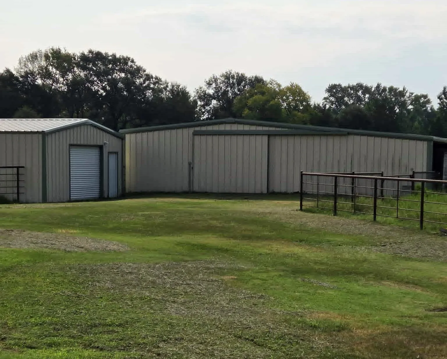 View of workshop with lightly sprayed insulation and electric.  Barn has 4 stalls and doors that open to the back pasture and side pen.