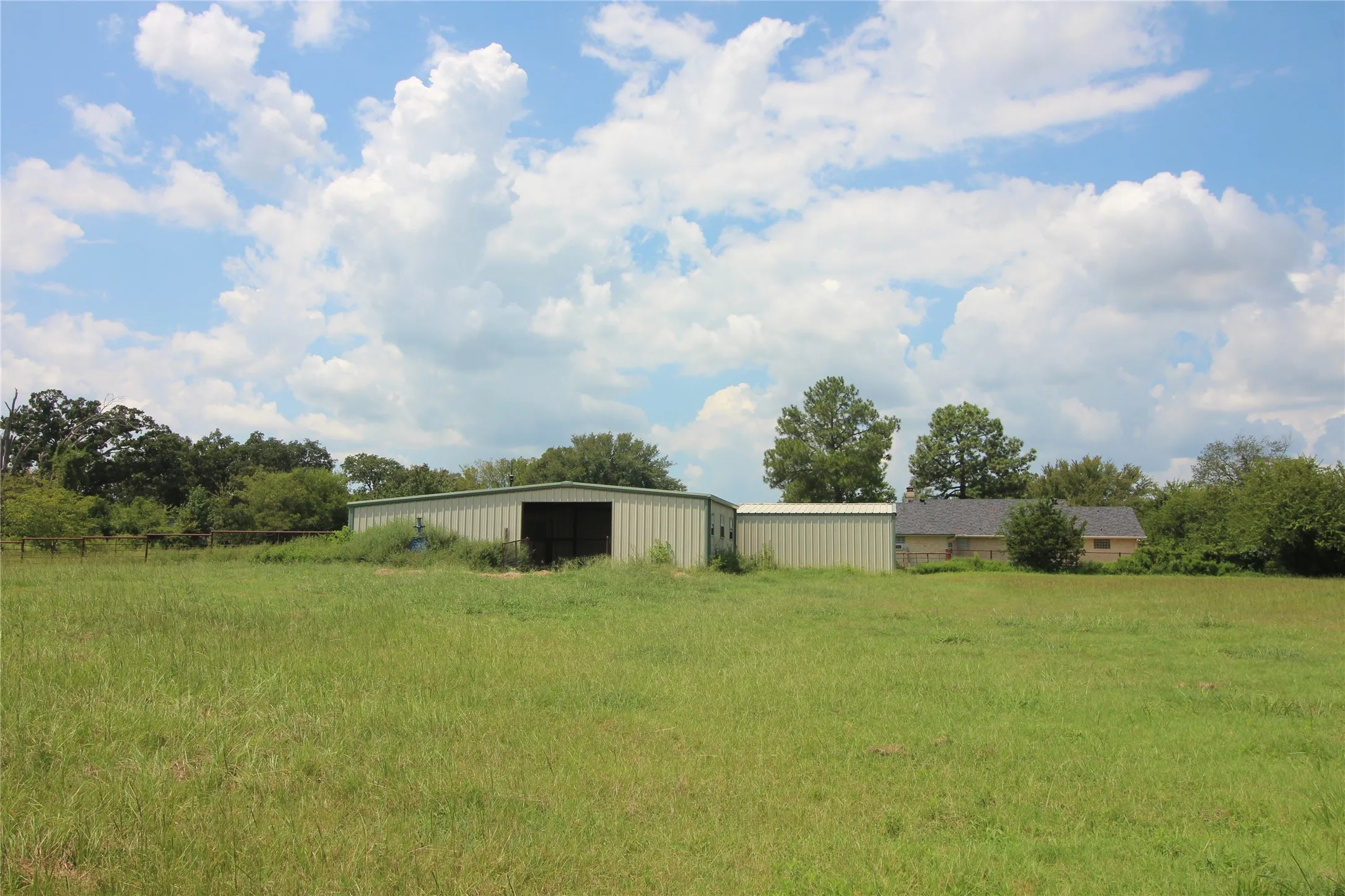 Looking from the tank to the back of the barn, workshop and home.