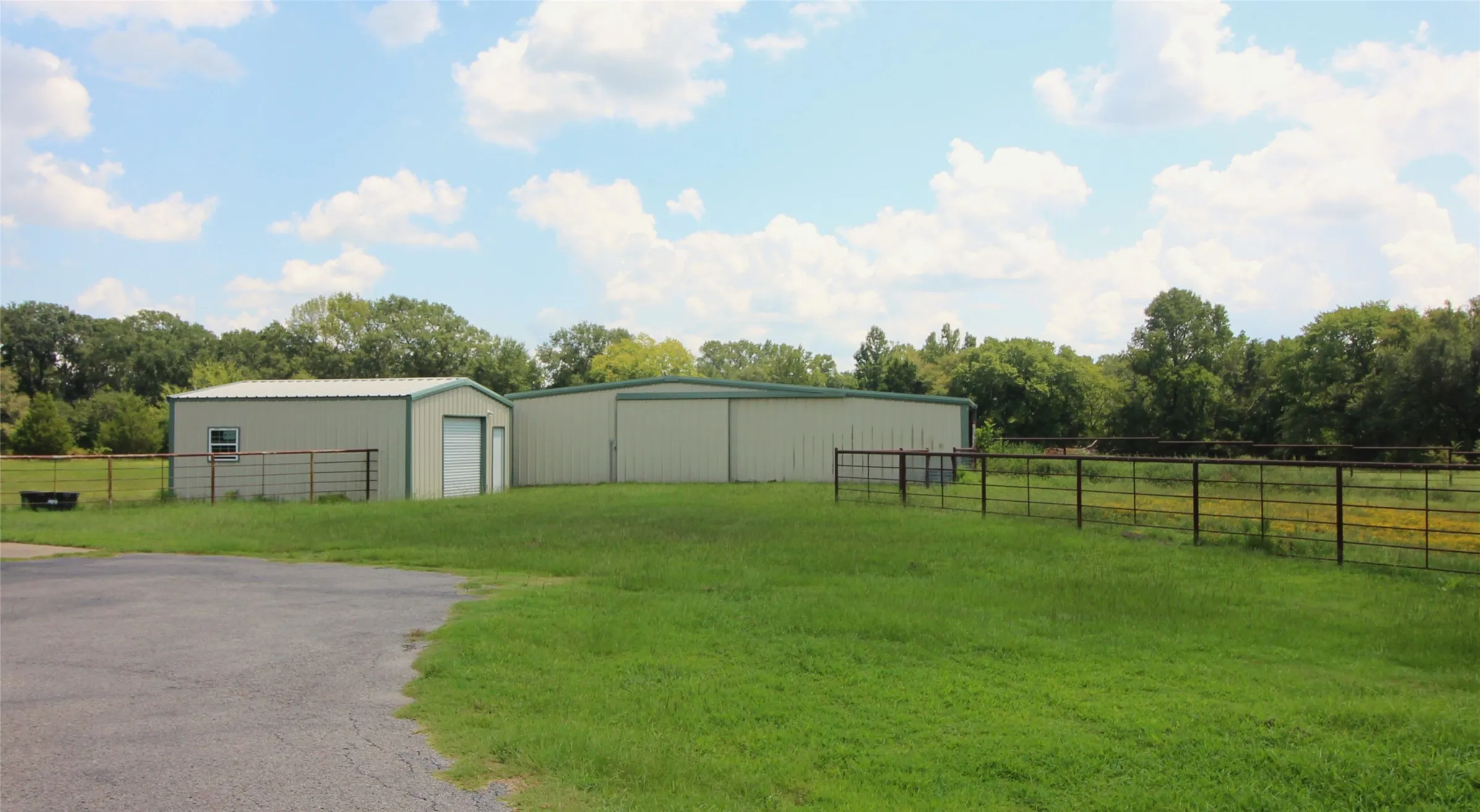 Workshop with light sprayed insulation.  Barn has four stalls and opens to the back pasture and side pen.