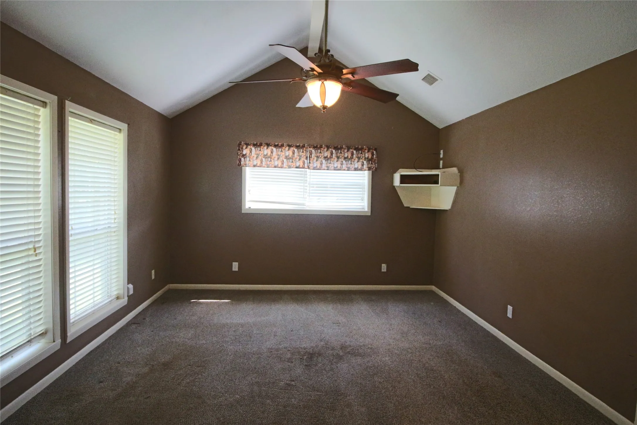 Master bedroom featuring carpet, a ceiling fan and ensuite bathroom