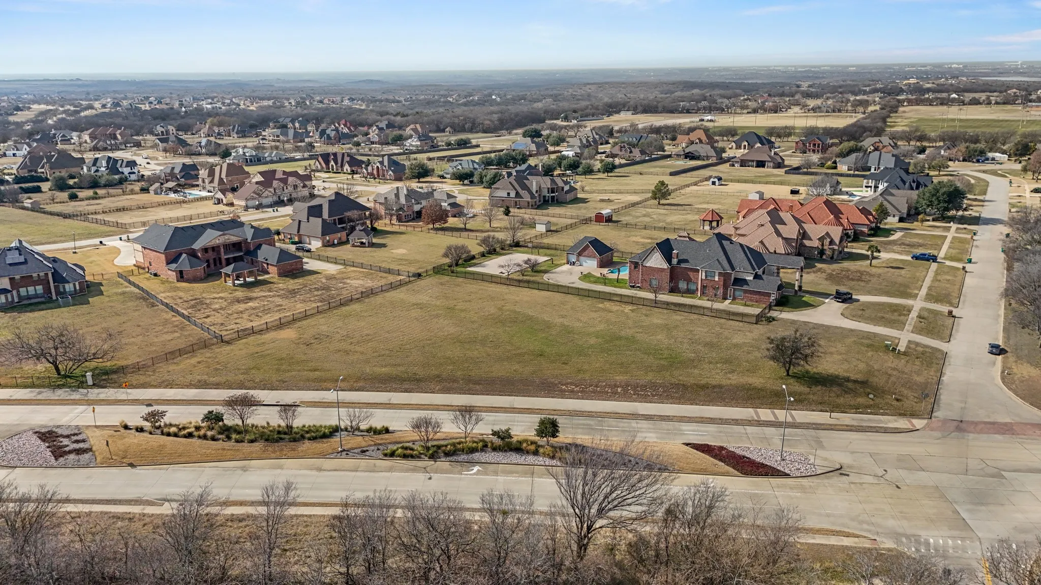 Aerial view of property's location with nearby suburban area