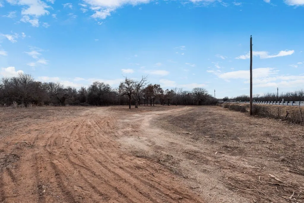 View of road on acreage cleared and ready to build, view of electric poll