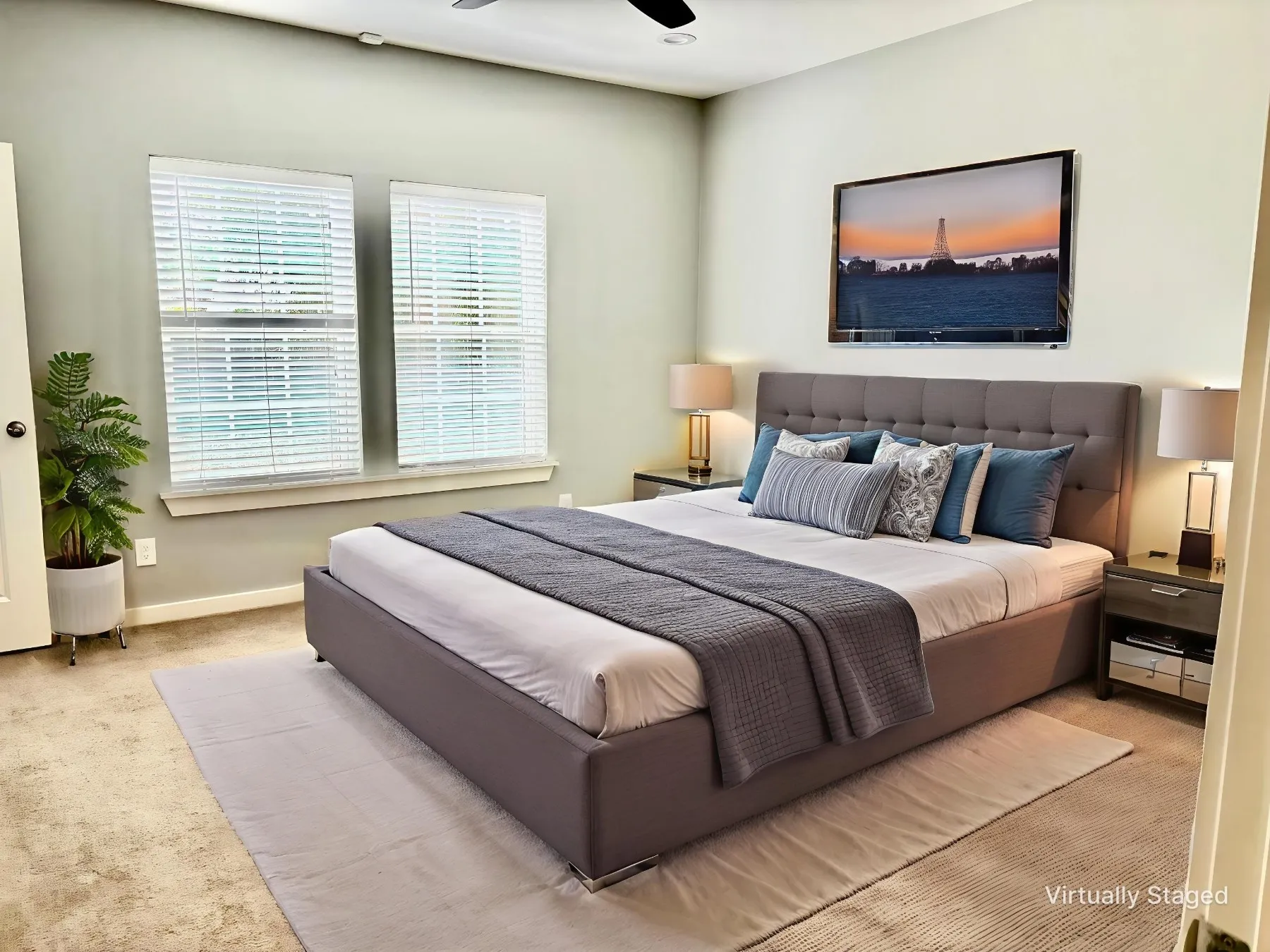 Carpeted bedroom with a ceiling fan and baseboards