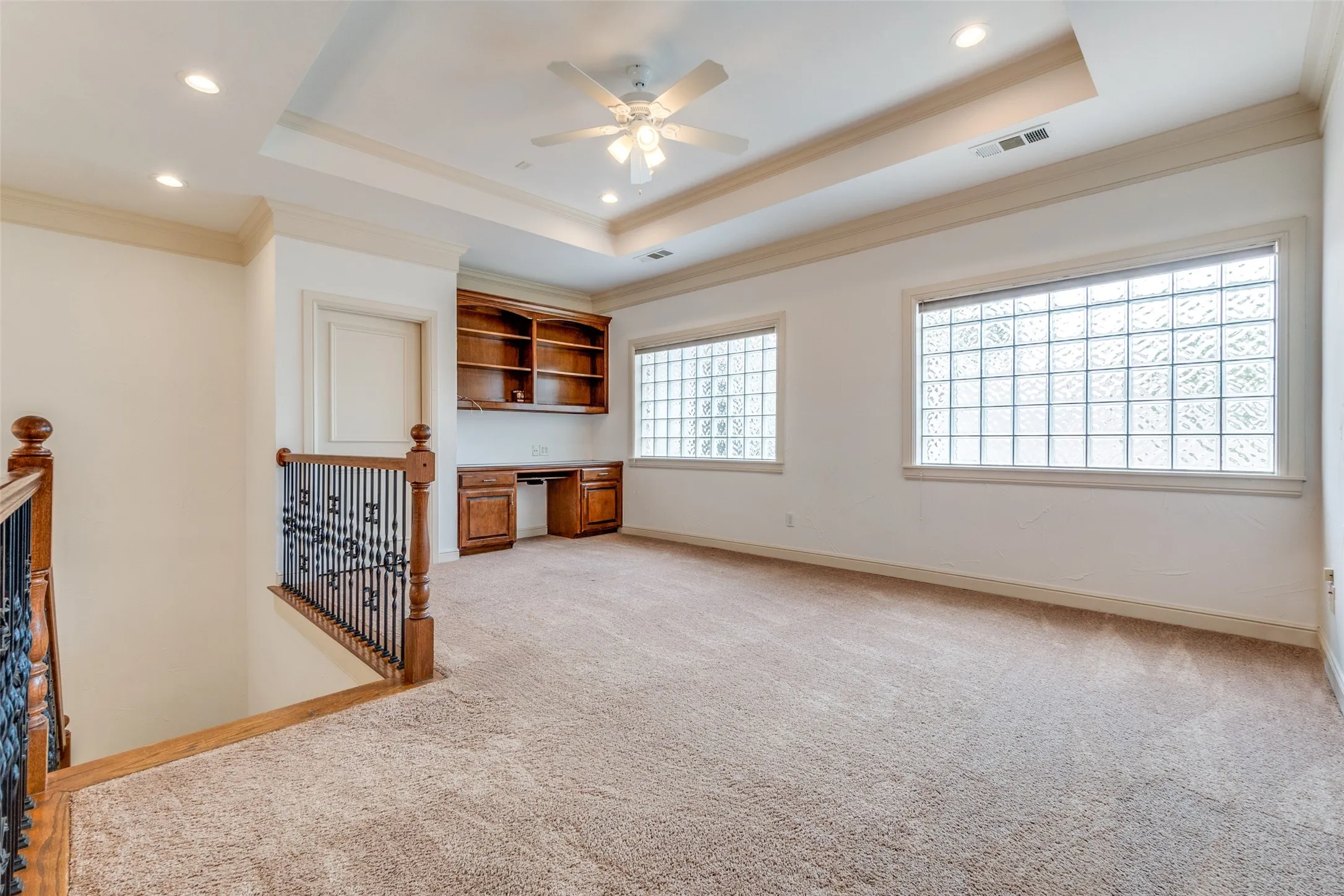 2nd floor landing with built in desk and cabinets
