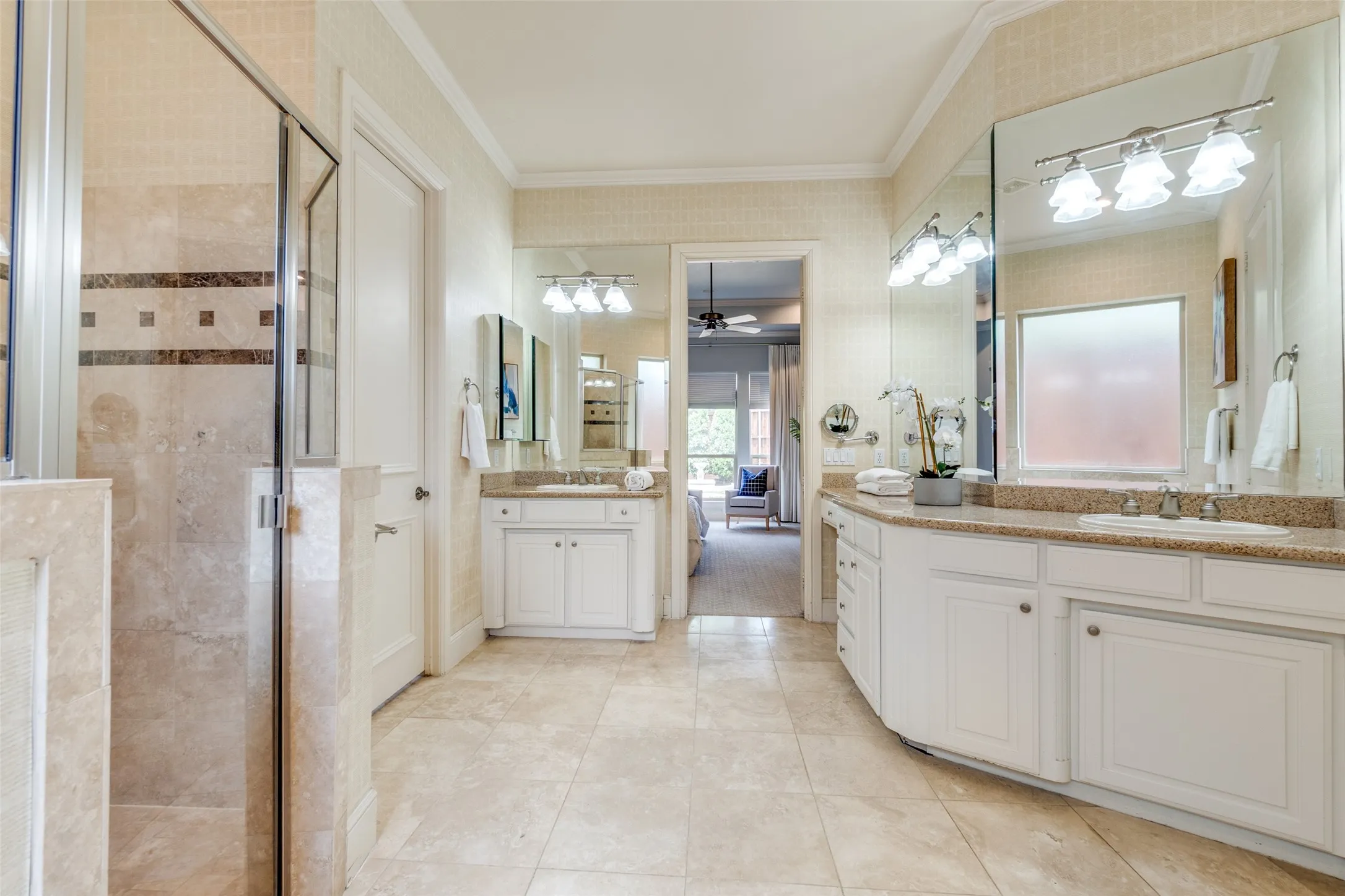 Bathroom featuring a shower stall, ornamental molding, and a sink