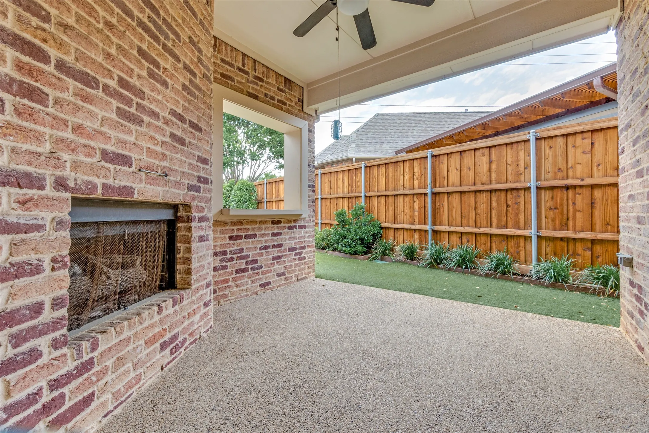 Covered outdoor patio with wood burning fireplace