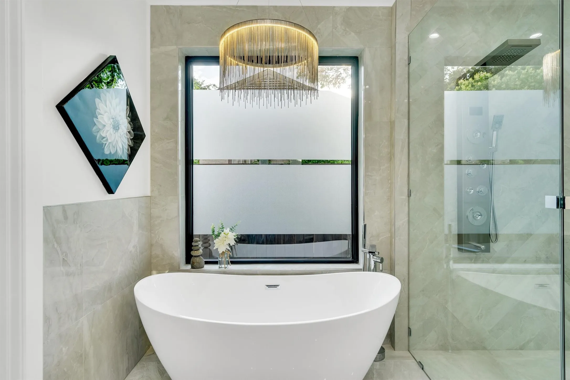 Bathroom with a freestanding tub, a shower stall, and tile walls