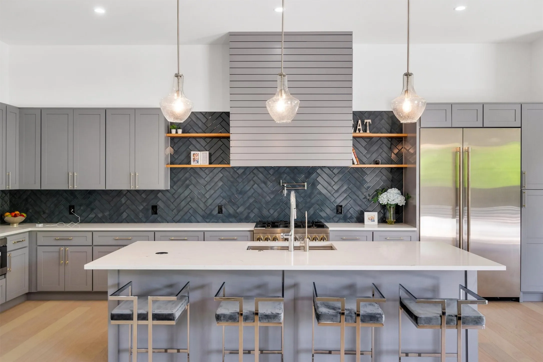 Kitchen featuring gray cabinets, open shelves, and light wood-style flooring