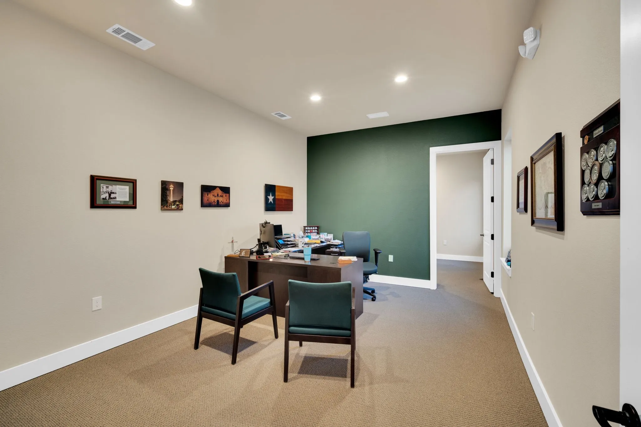 Comfortable office area with an accent wall, offering a professional space to meet with clients.
