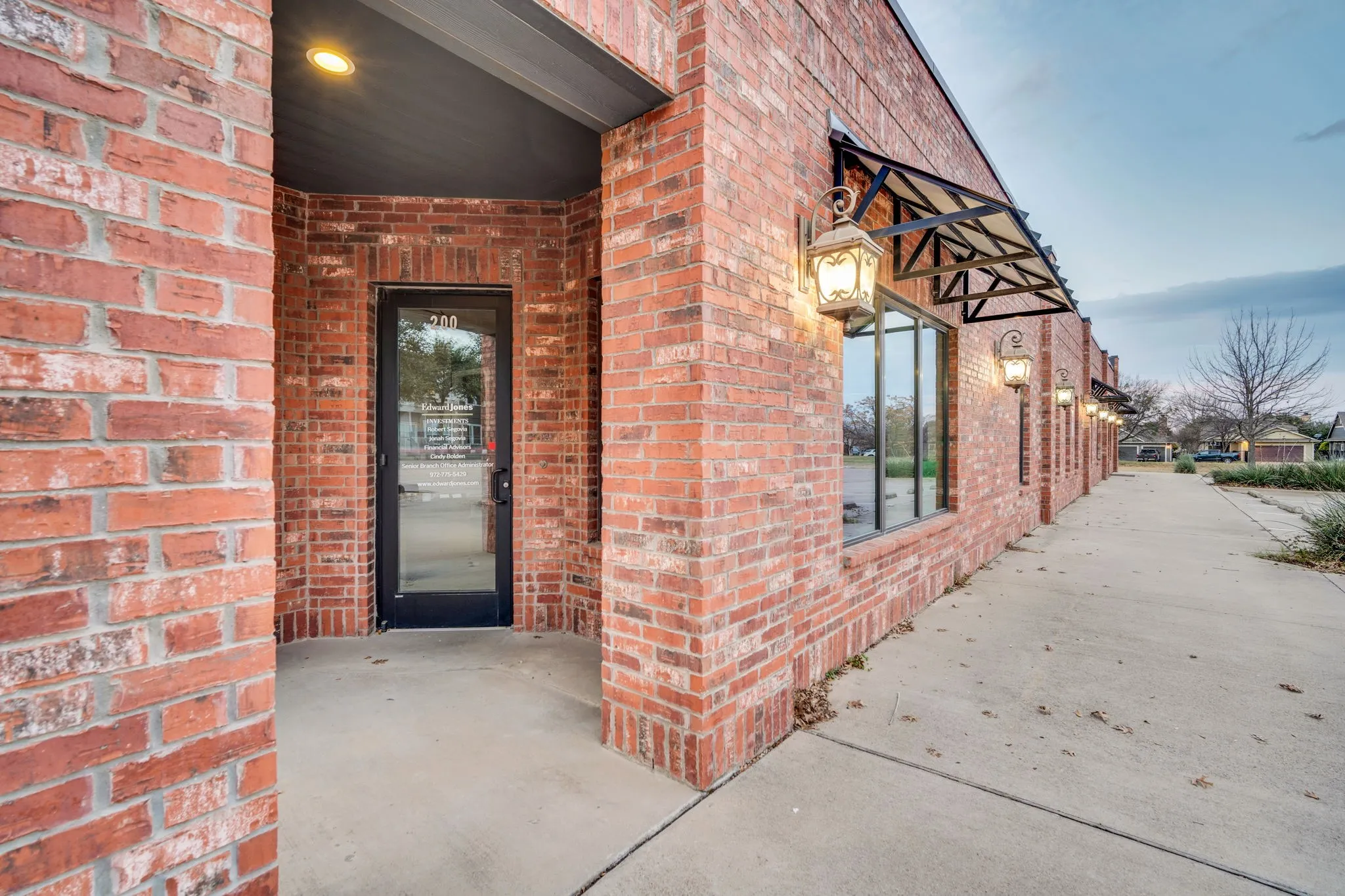Elegant entryway framed by classic brick and a stylish awning, creating a professional first impression.