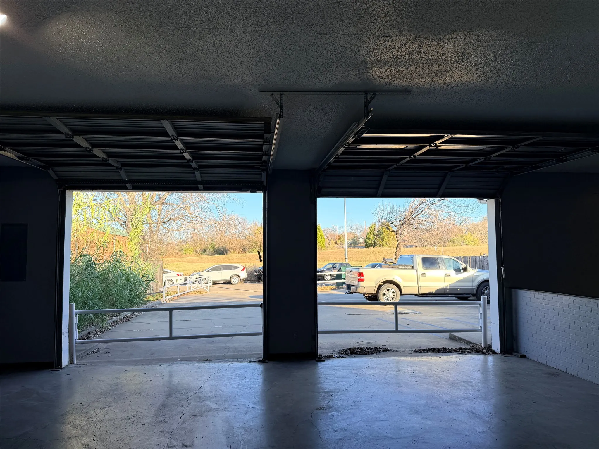 garage bay with concrete floors and wide open vehicle/storage space.
