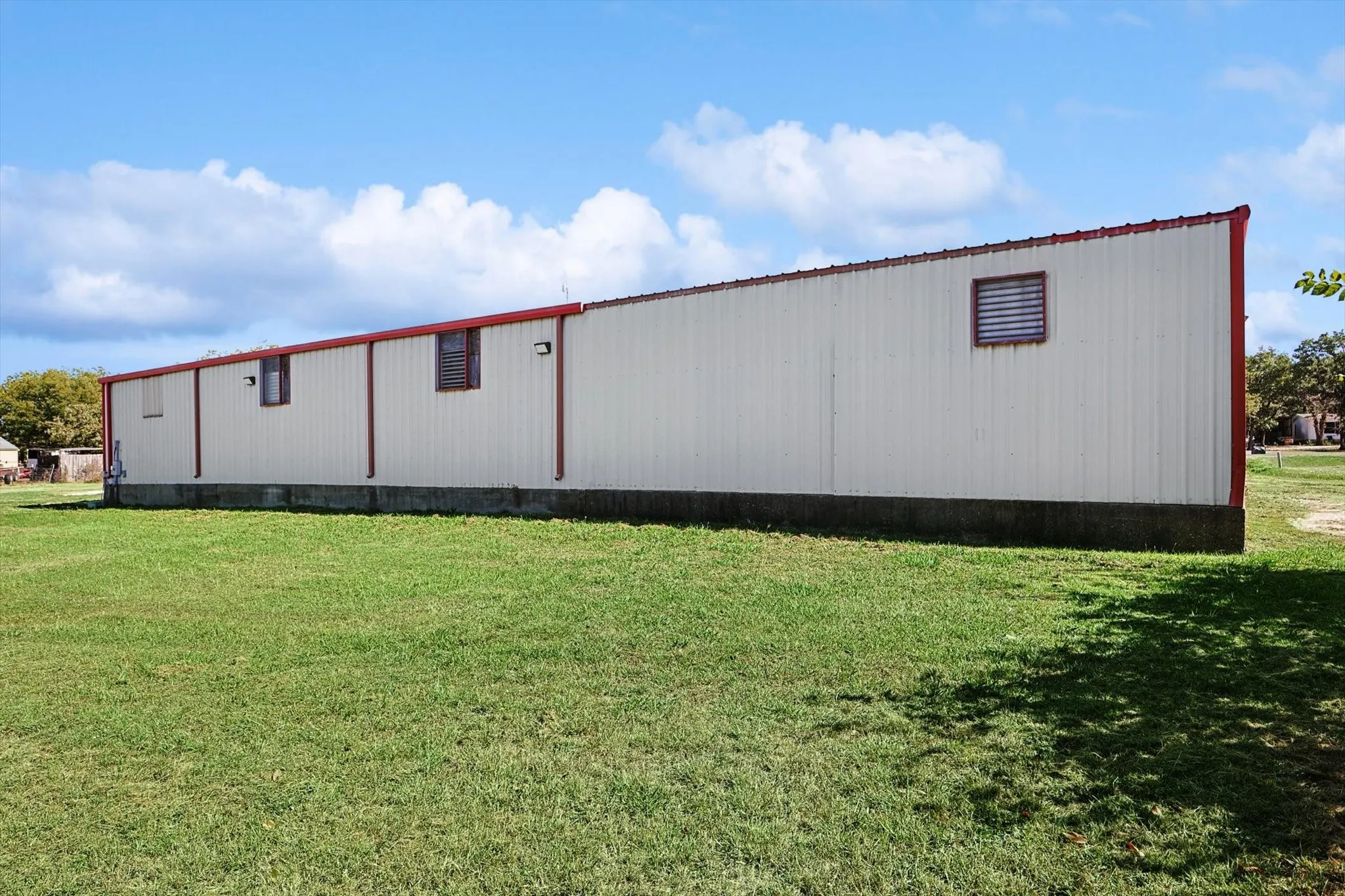 Rear view of property with a yard