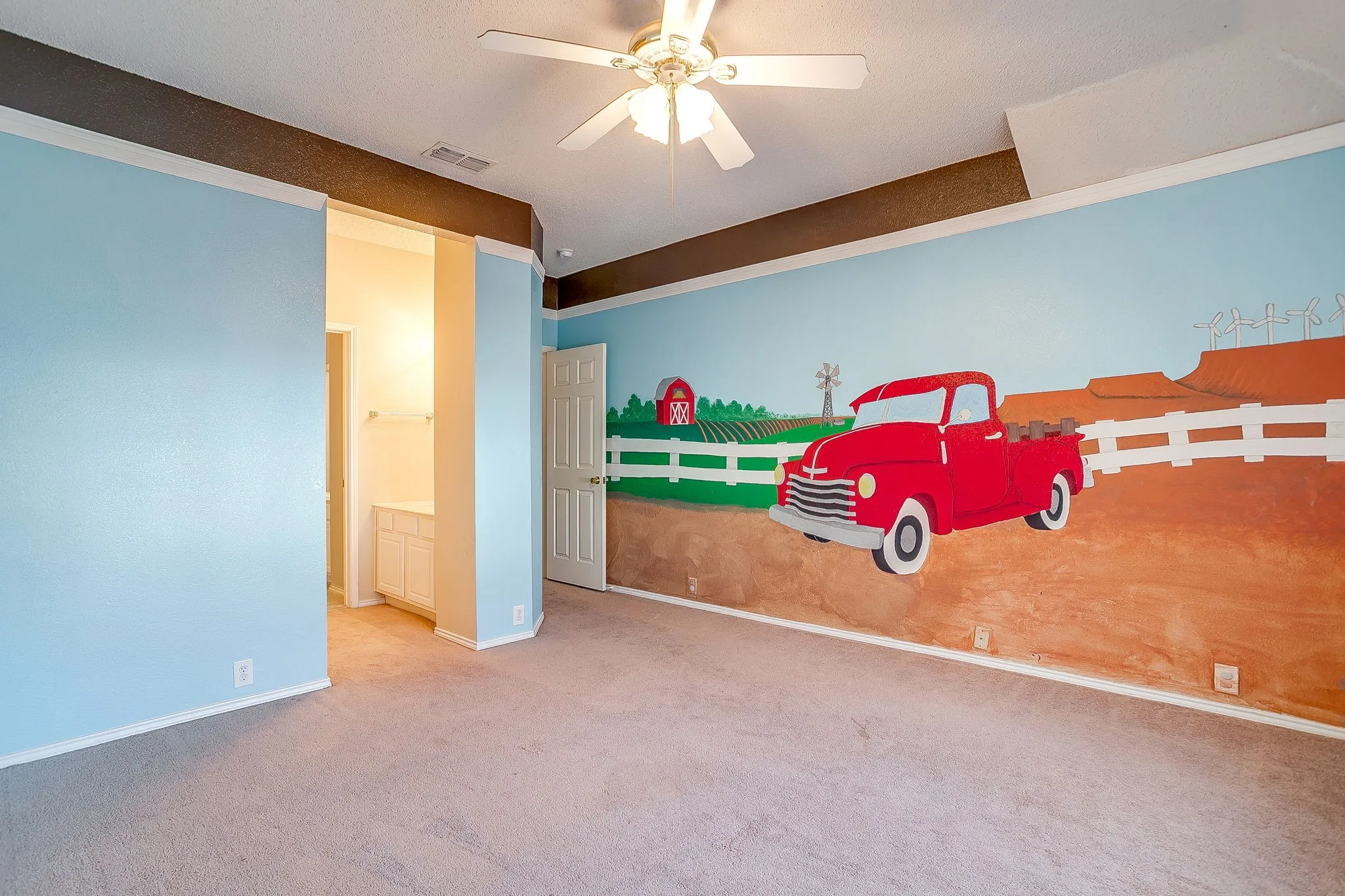 Unfurnished bedroom featuring carpet flooring, ceiling fan, and connected bathroom