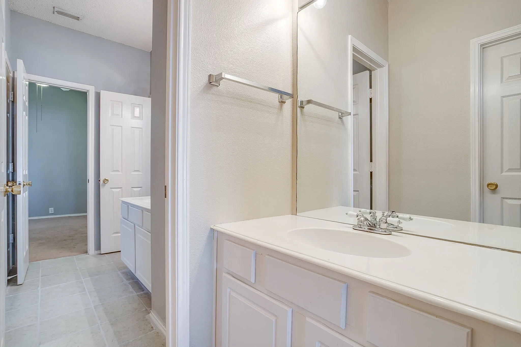 Bathroom featuring vanity and light tile patterned flooring