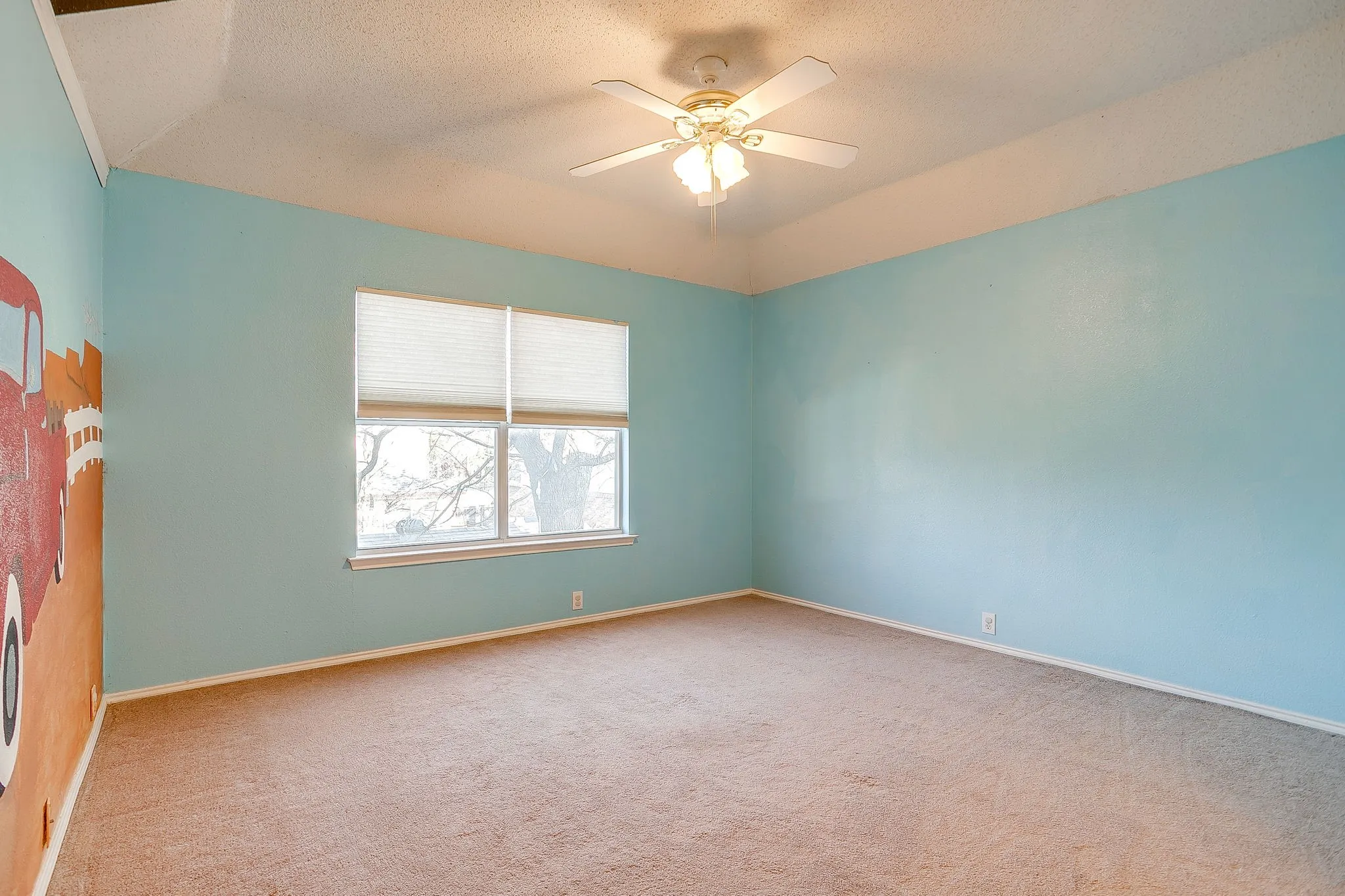 Spare room featuring ceiling fan and carpet floors
