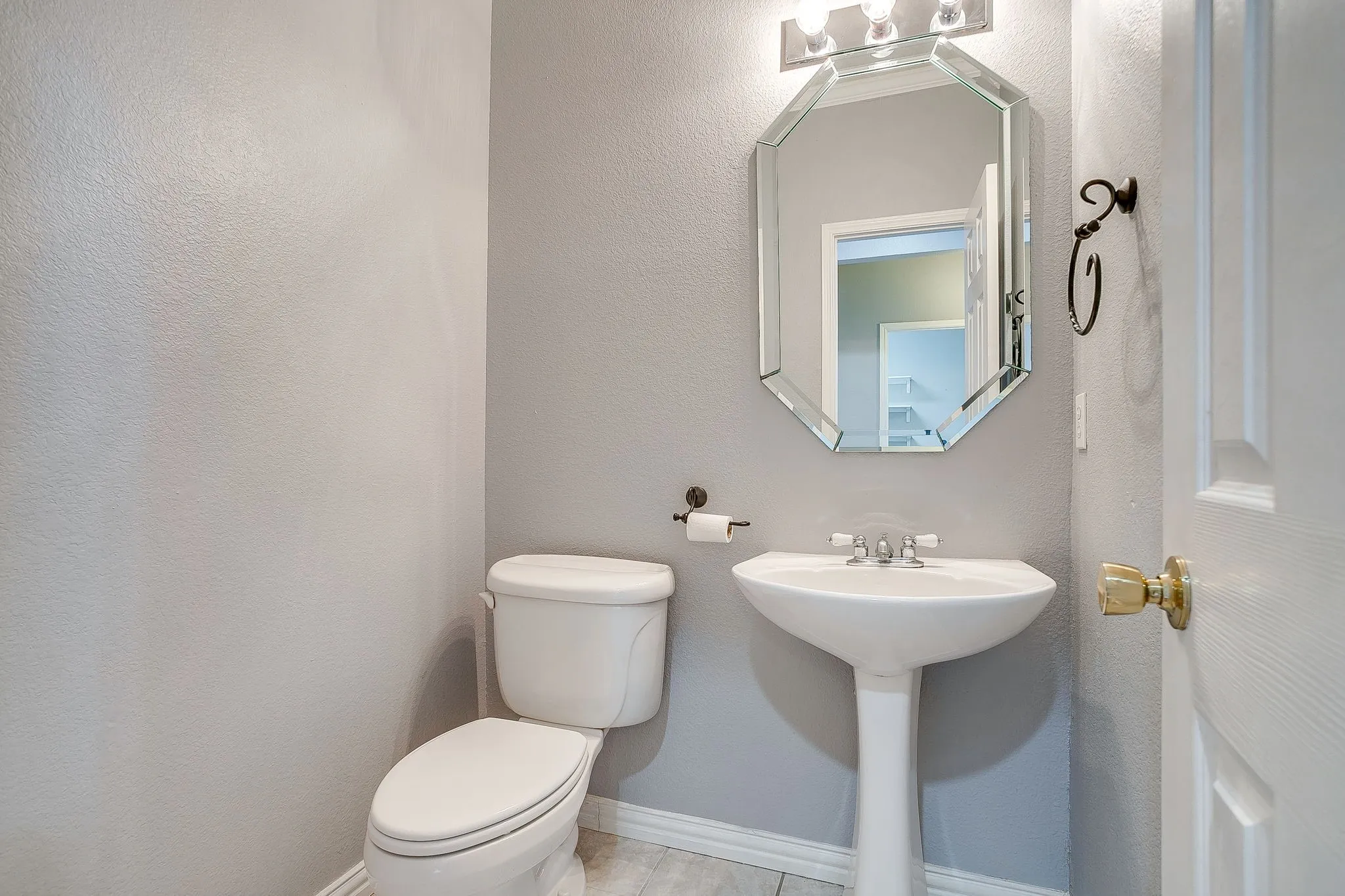 Half bathroom with toilet and a textured wall
