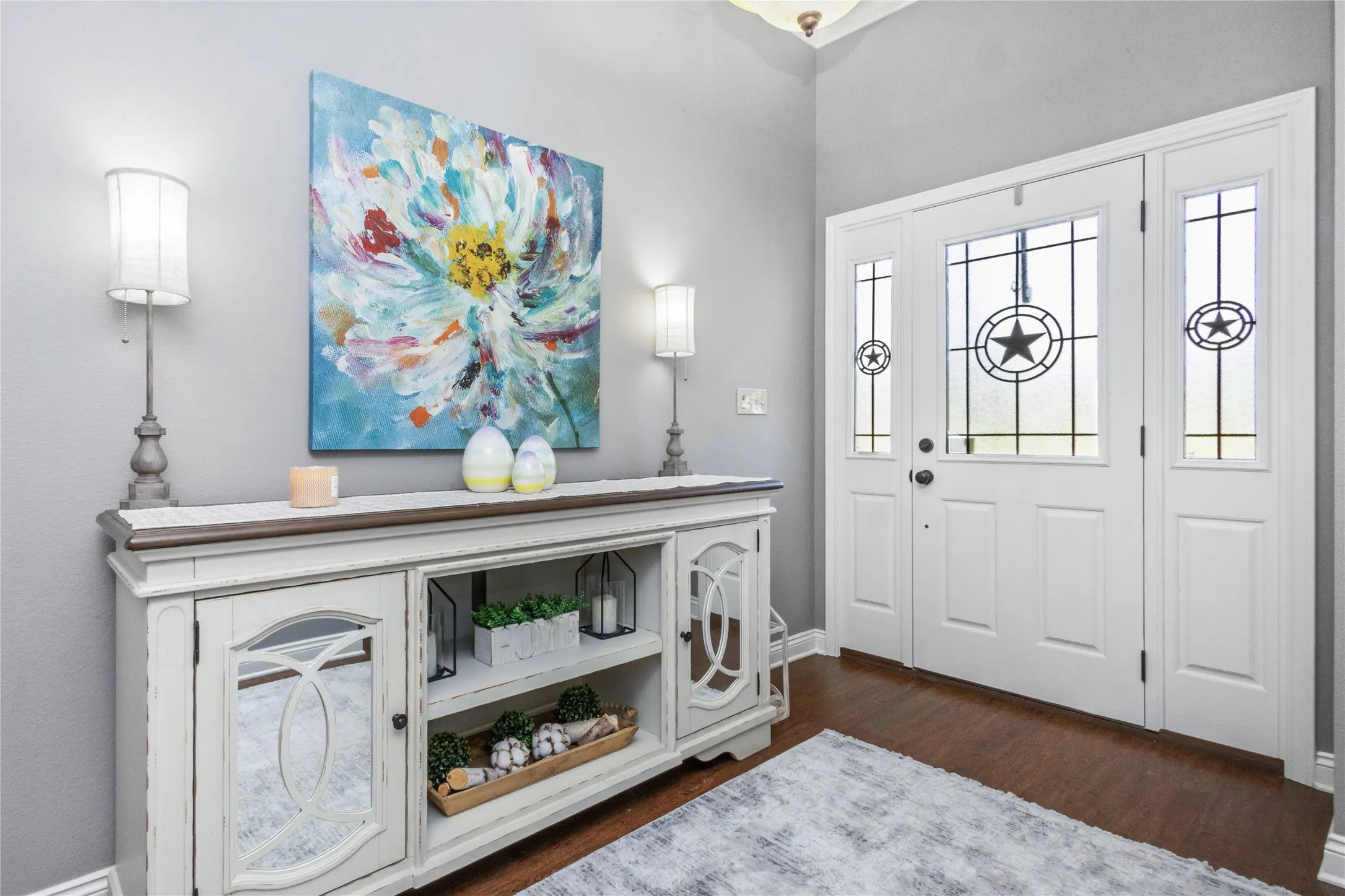 Foyer with dark wood finished floors and baseboards