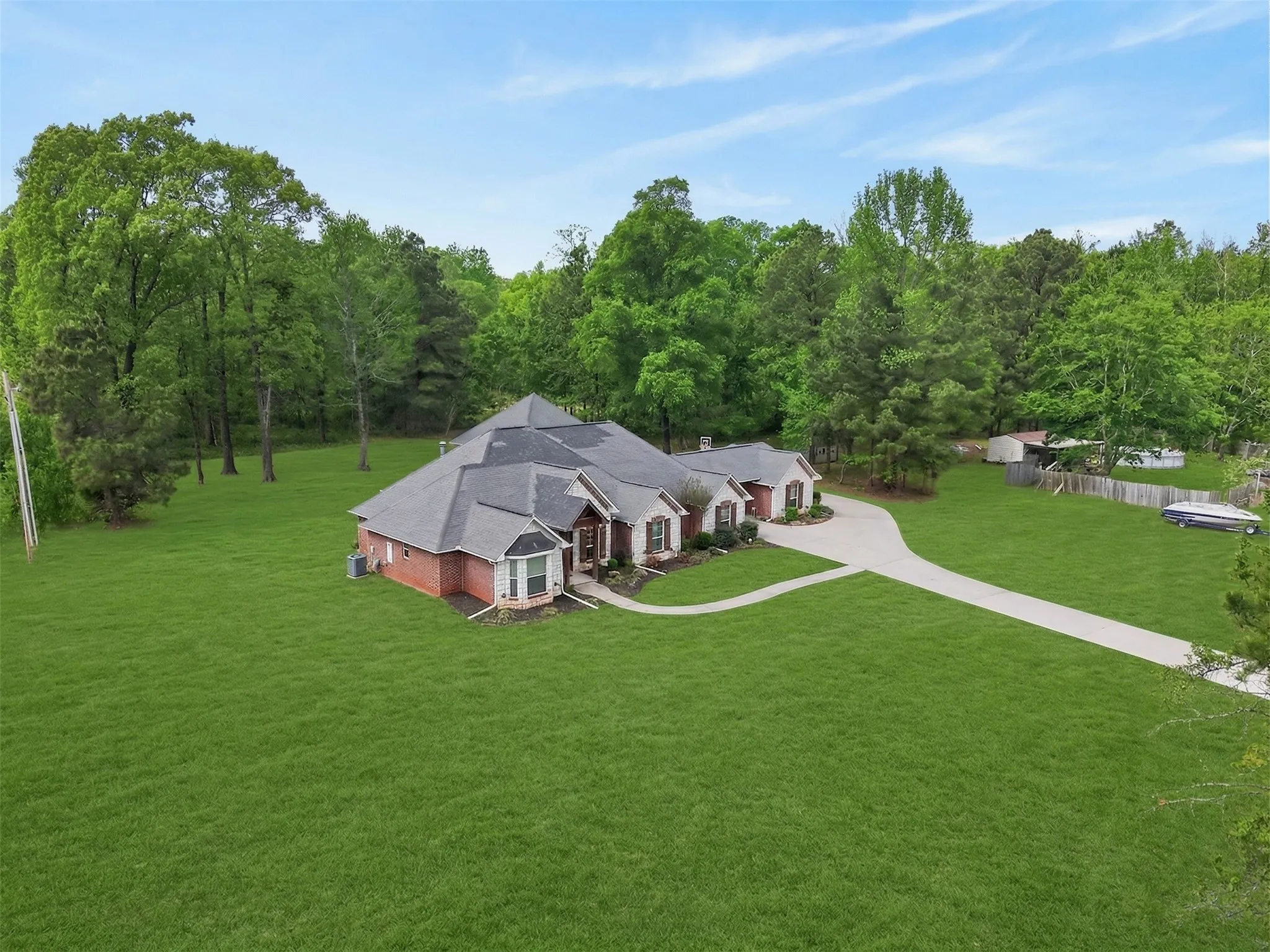 View from above of property with a tree filled landscape