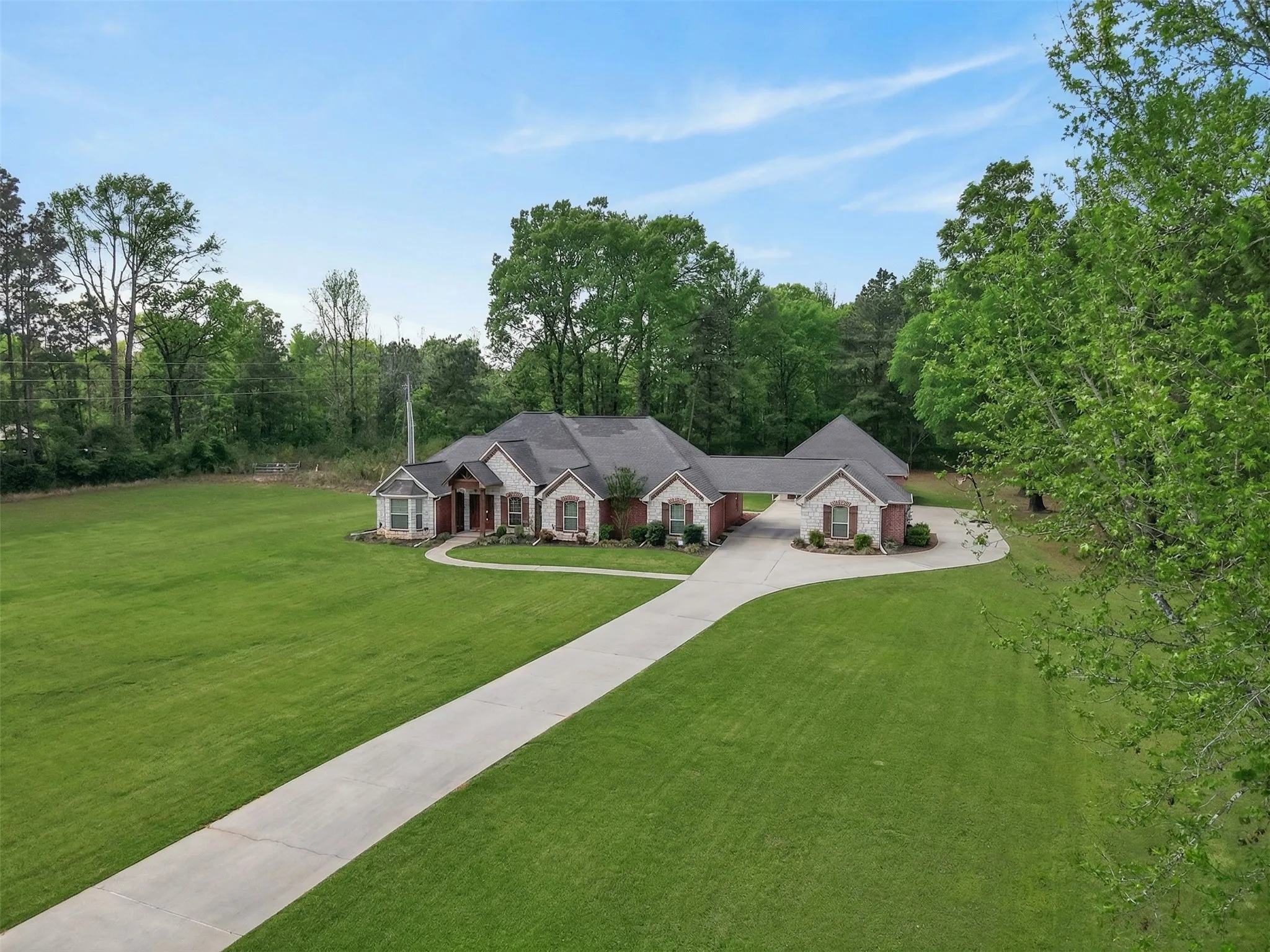 Single story home with driveway and a front yard