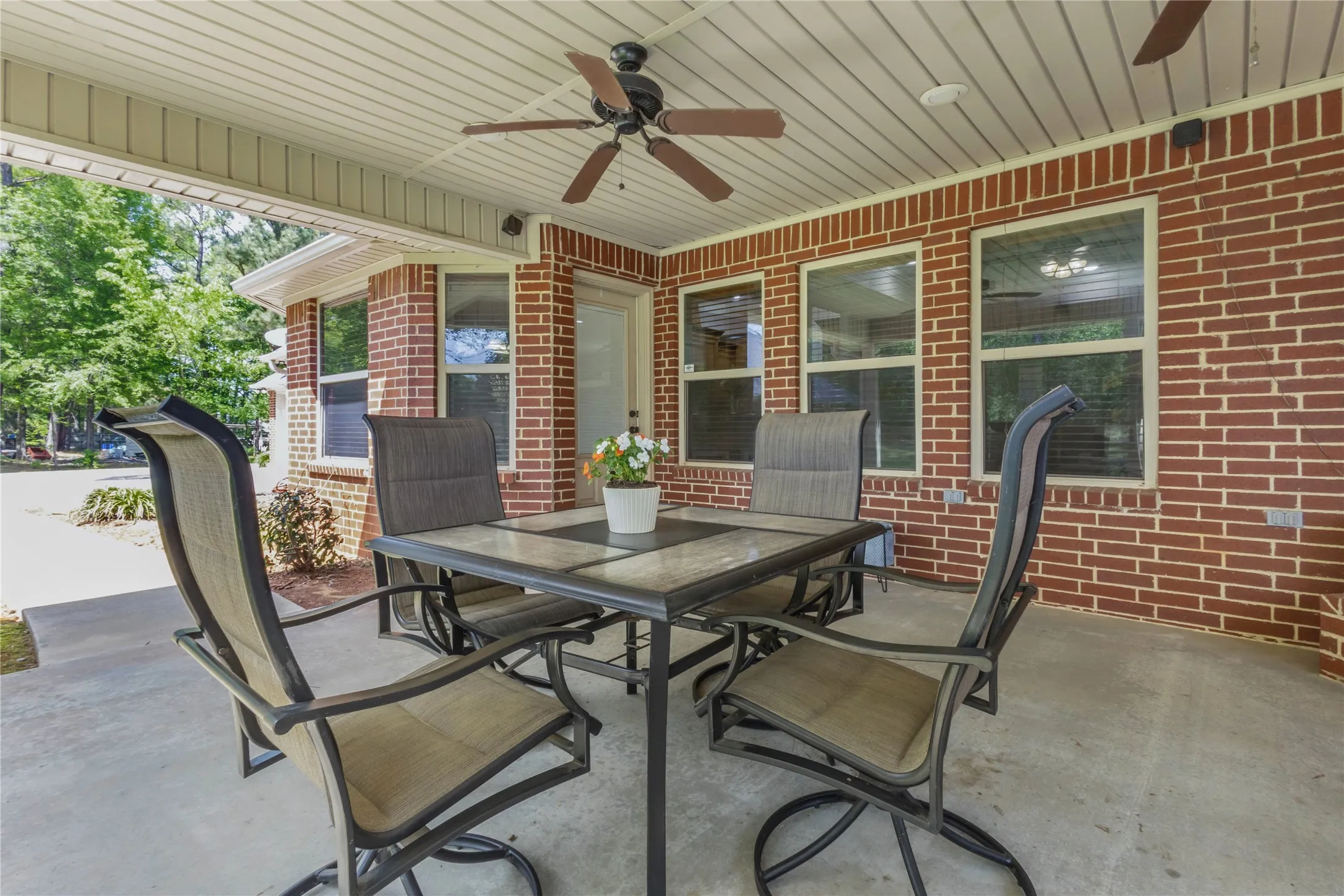 View of patio with ceiling fan and outdoor dining area
