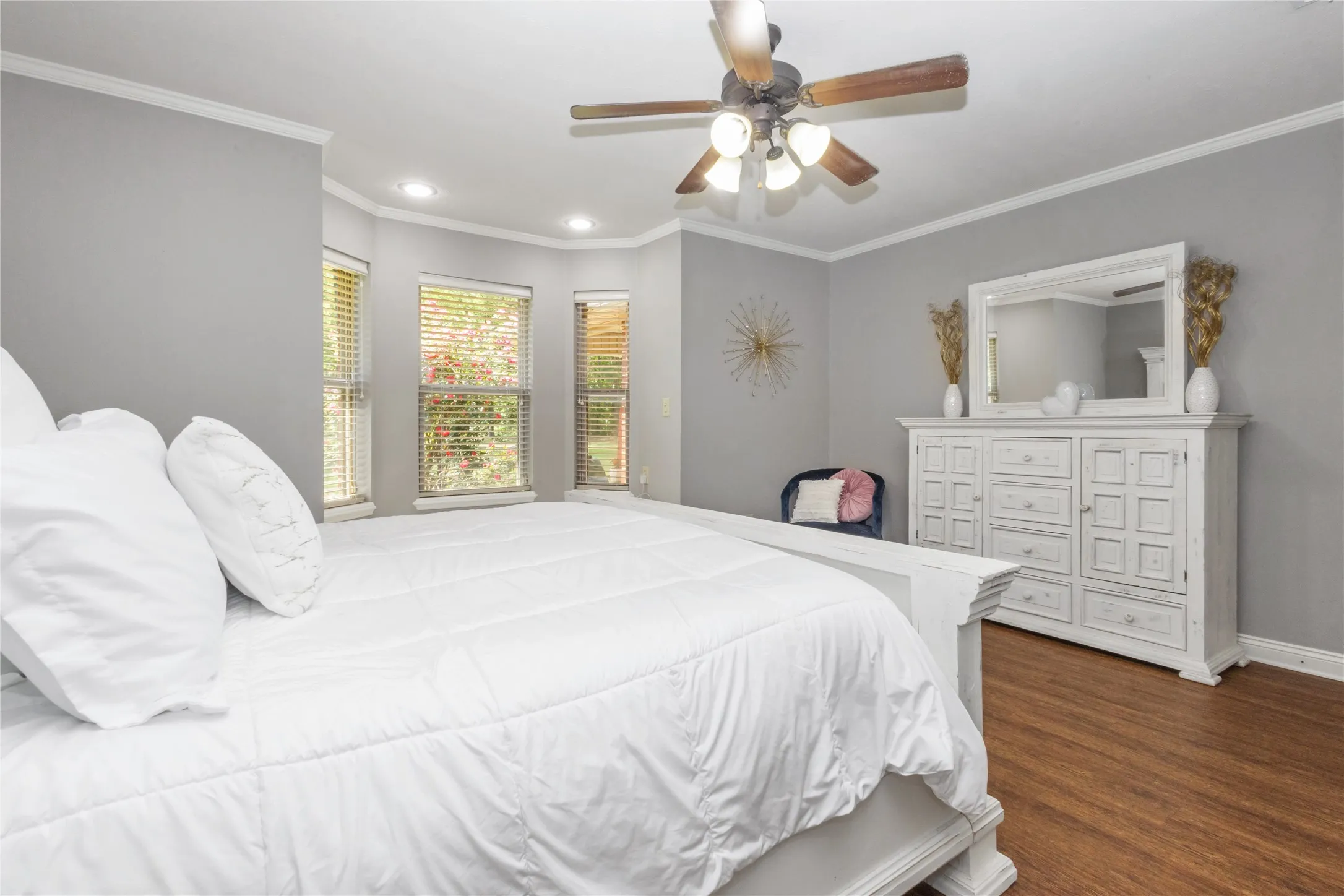 Bedroom with dark wood-style floors, ceiling fan, crown molding, and recessed lighting