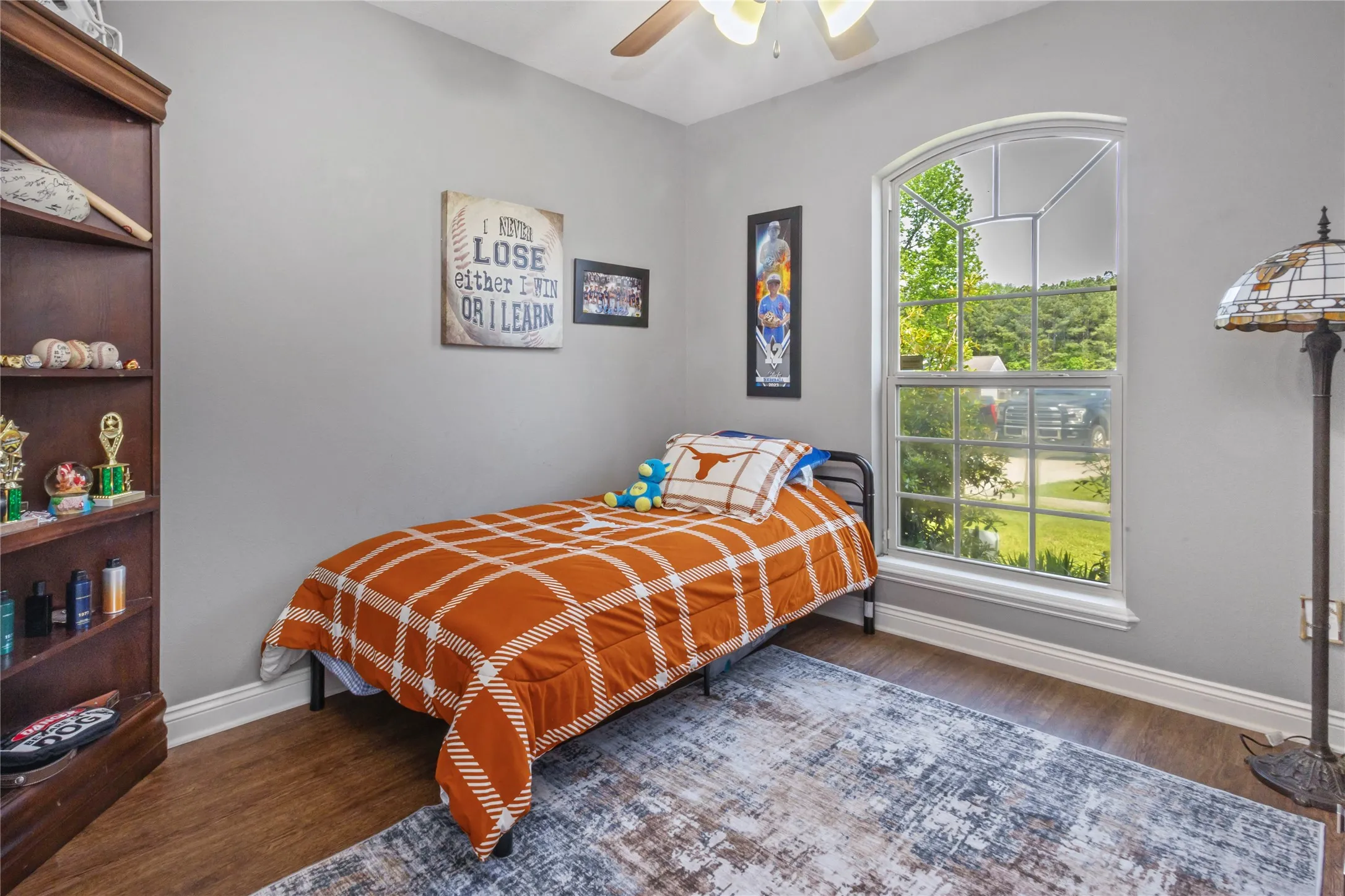 Bedroom featuring dark wood-style flooring and a ceiling fan