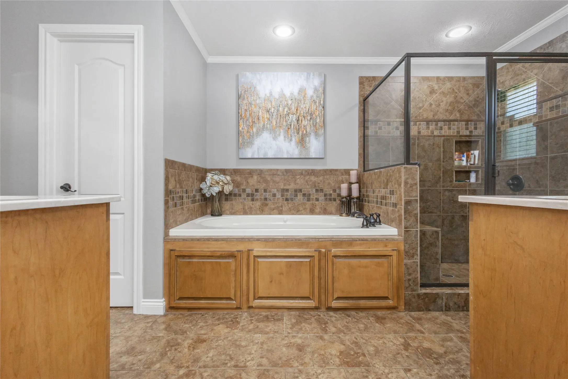 Full bathroom with a garden tub, crown molding, and a stall shower