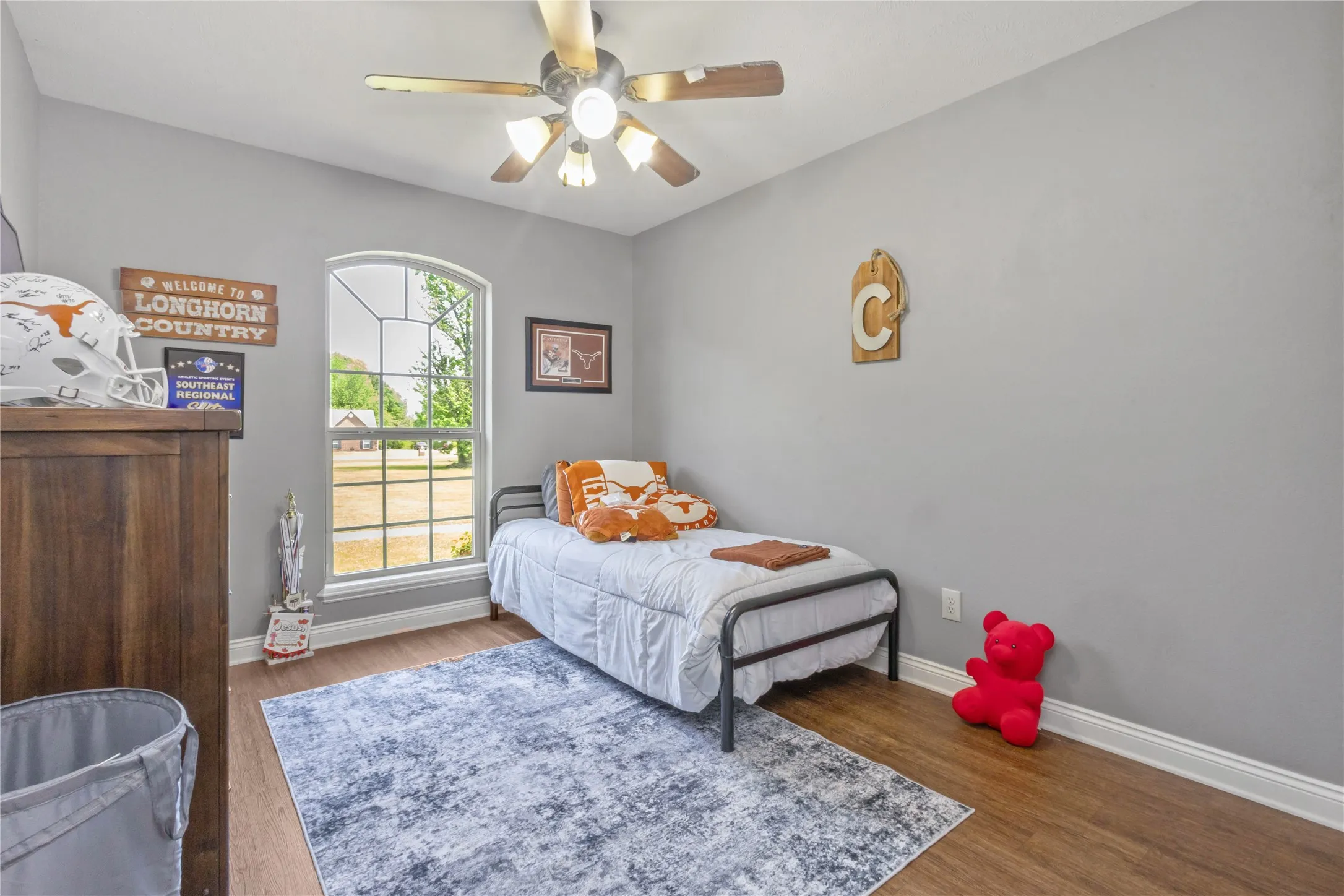 Bedroom with dark wood-type flooring and a ceiling fan