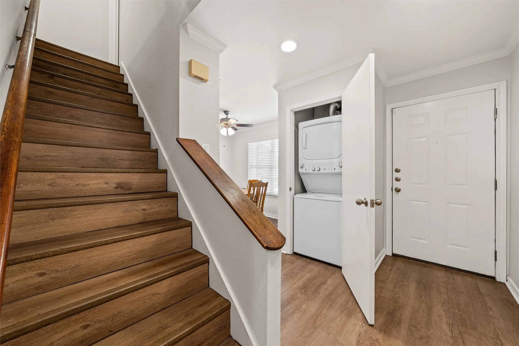Stairs with laundry closet in the background.  Washer-dryer included.