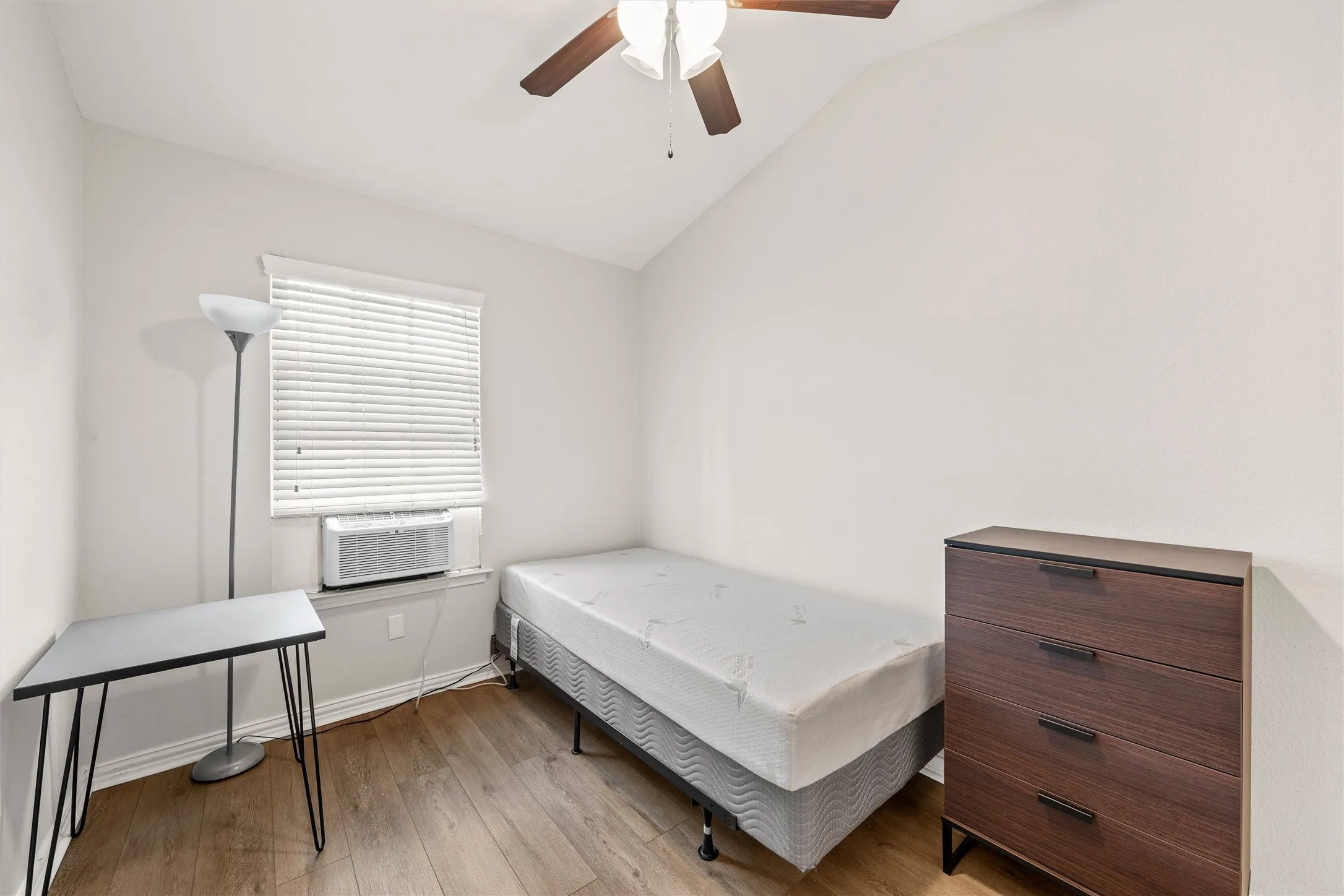 Bedroom 2. Cathedral ceiling, ceiling fan, and walk-in closet.
