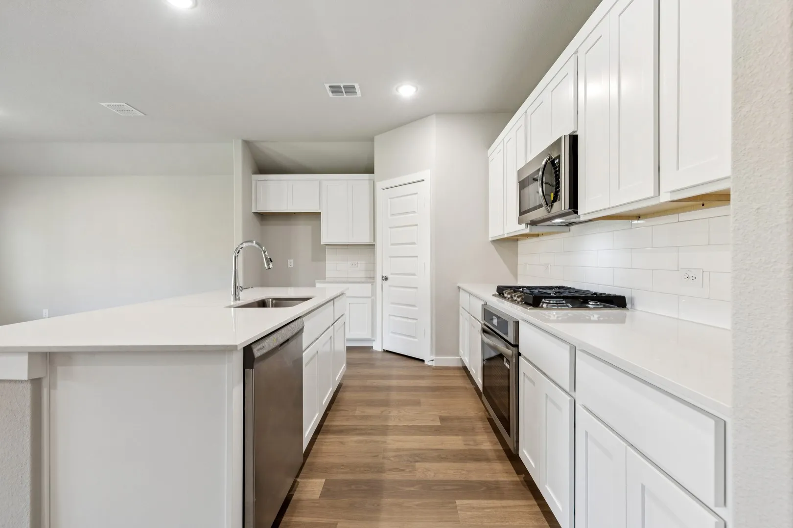 Kitchen in the Emmy II home plan by Trophy Signature Homes - REPRESENTATIVE PHOTO