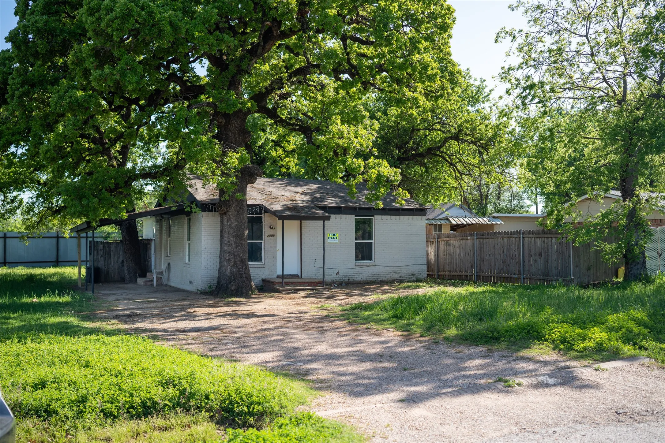 Ranch-style home featuring brick siding and driveway