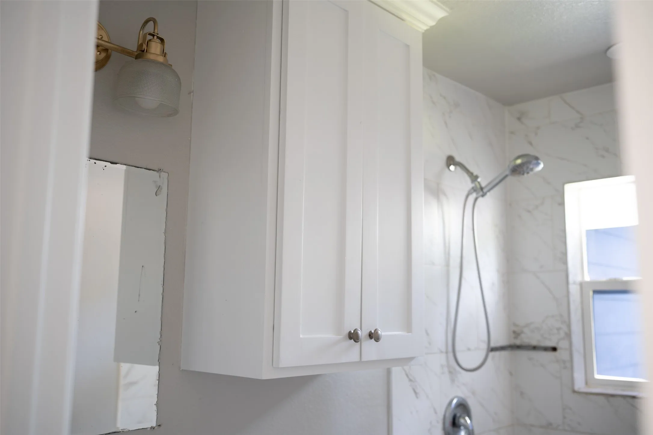 Full bath featuring a combined bath / shower with marble appearance