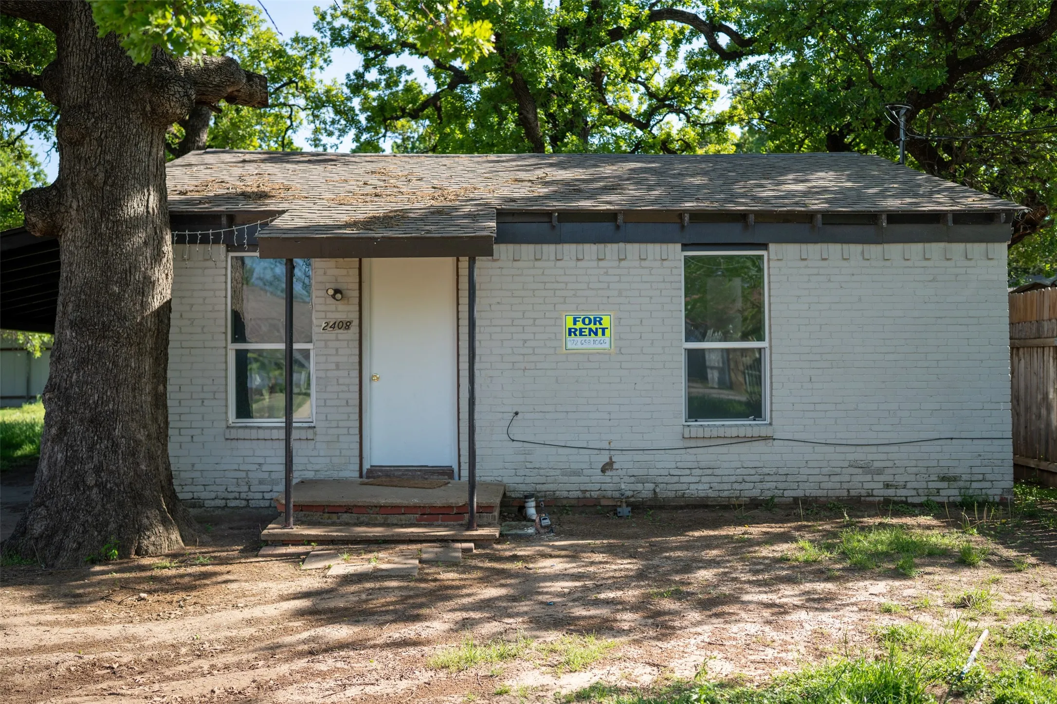 Ranch-style house with brick siding and roof with shingles