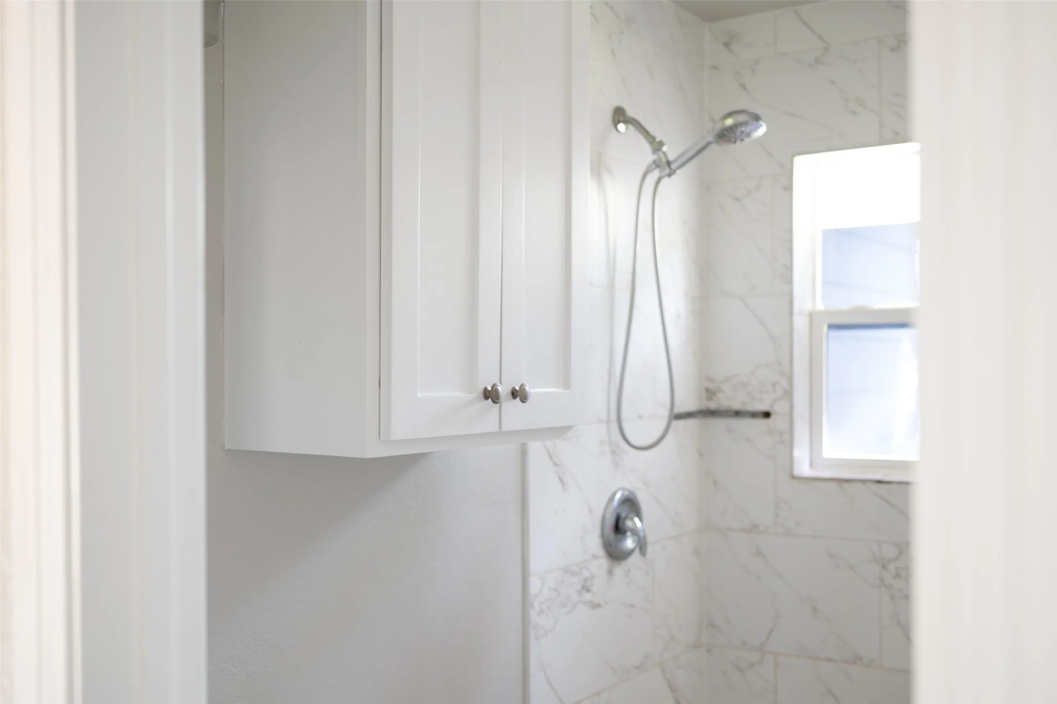 Full bathroom with a marble finish shower