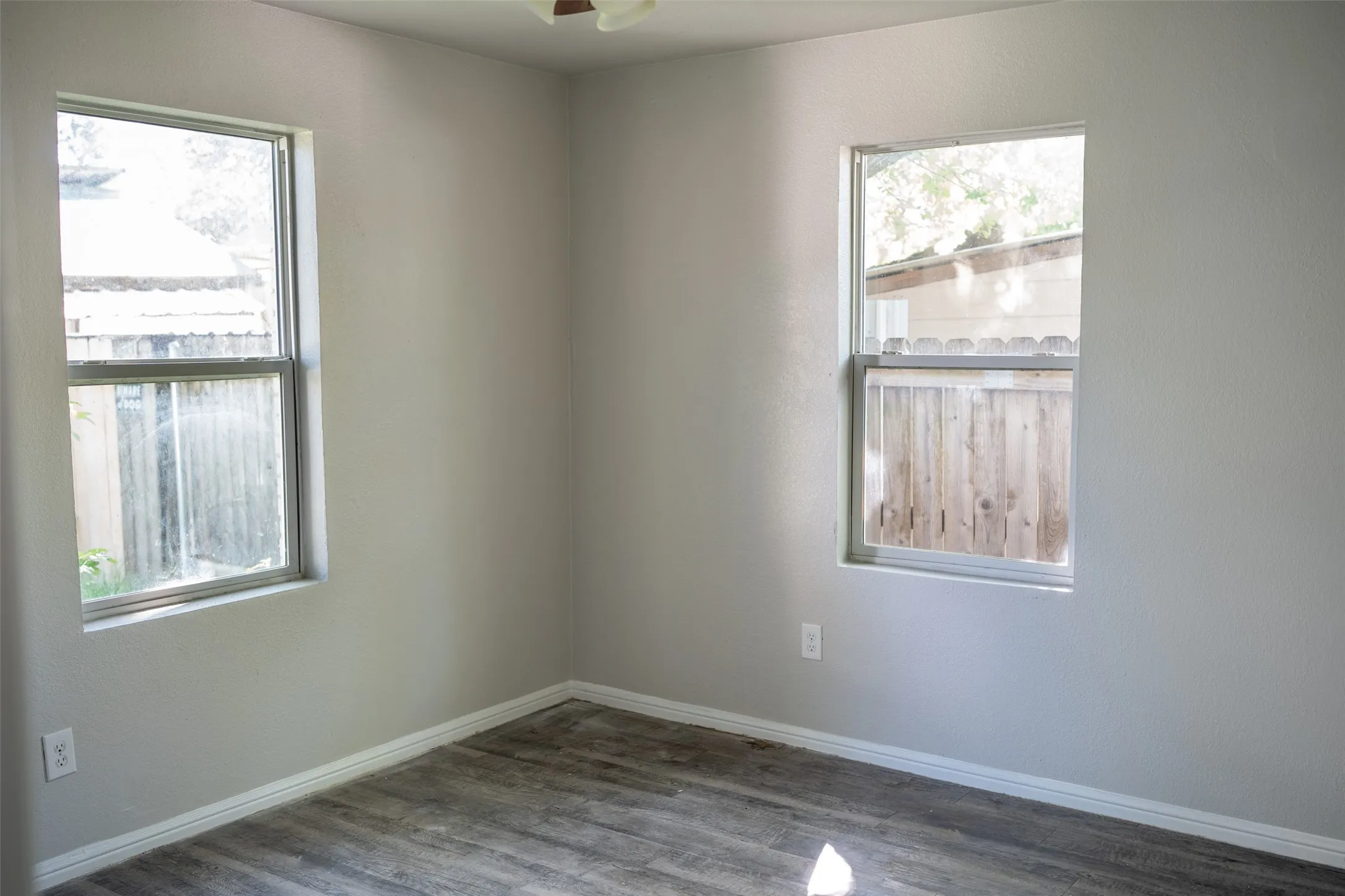 Spare room with wood finished floors and ceiling fan