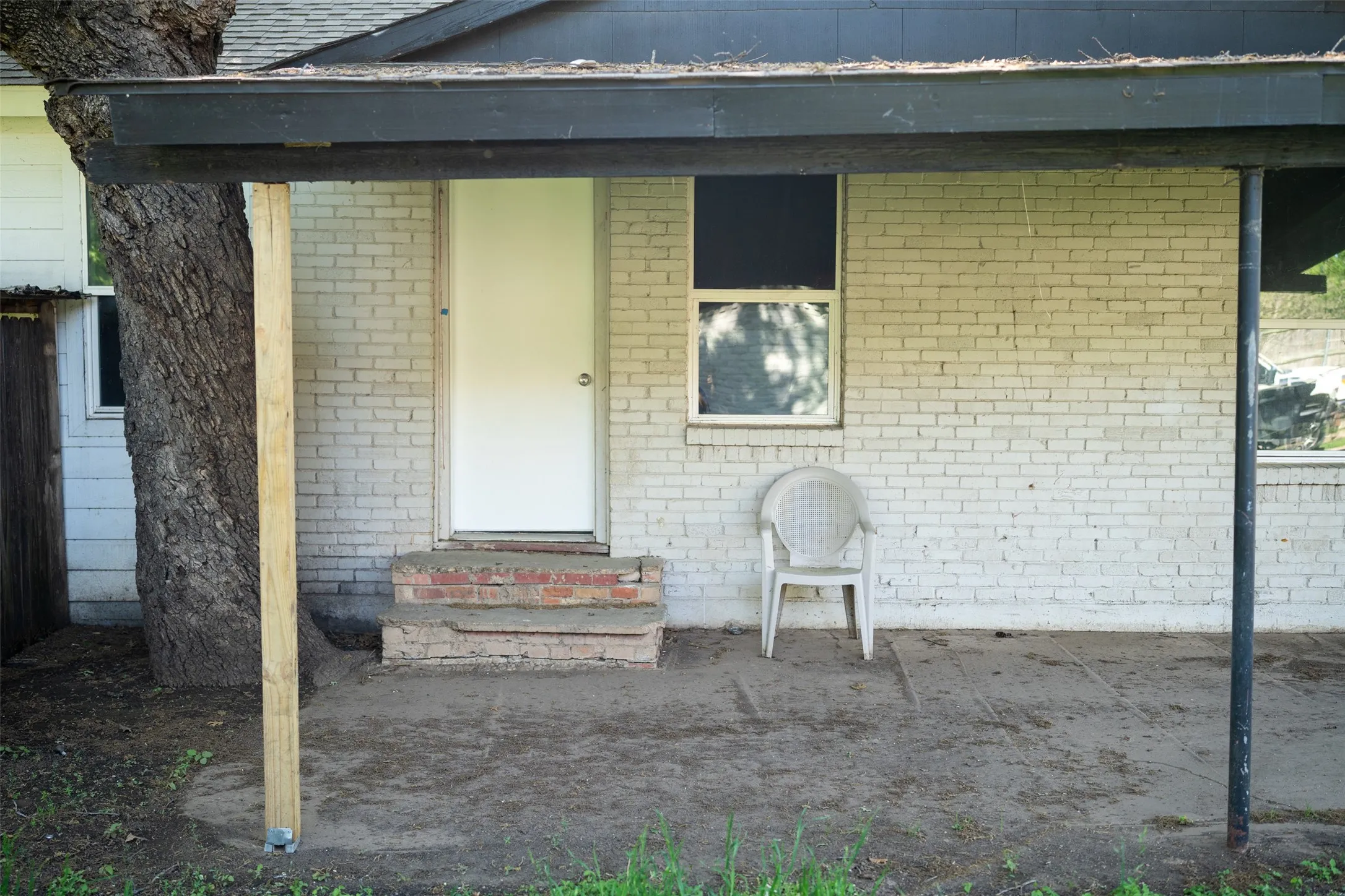 Doorway to property with brick siding