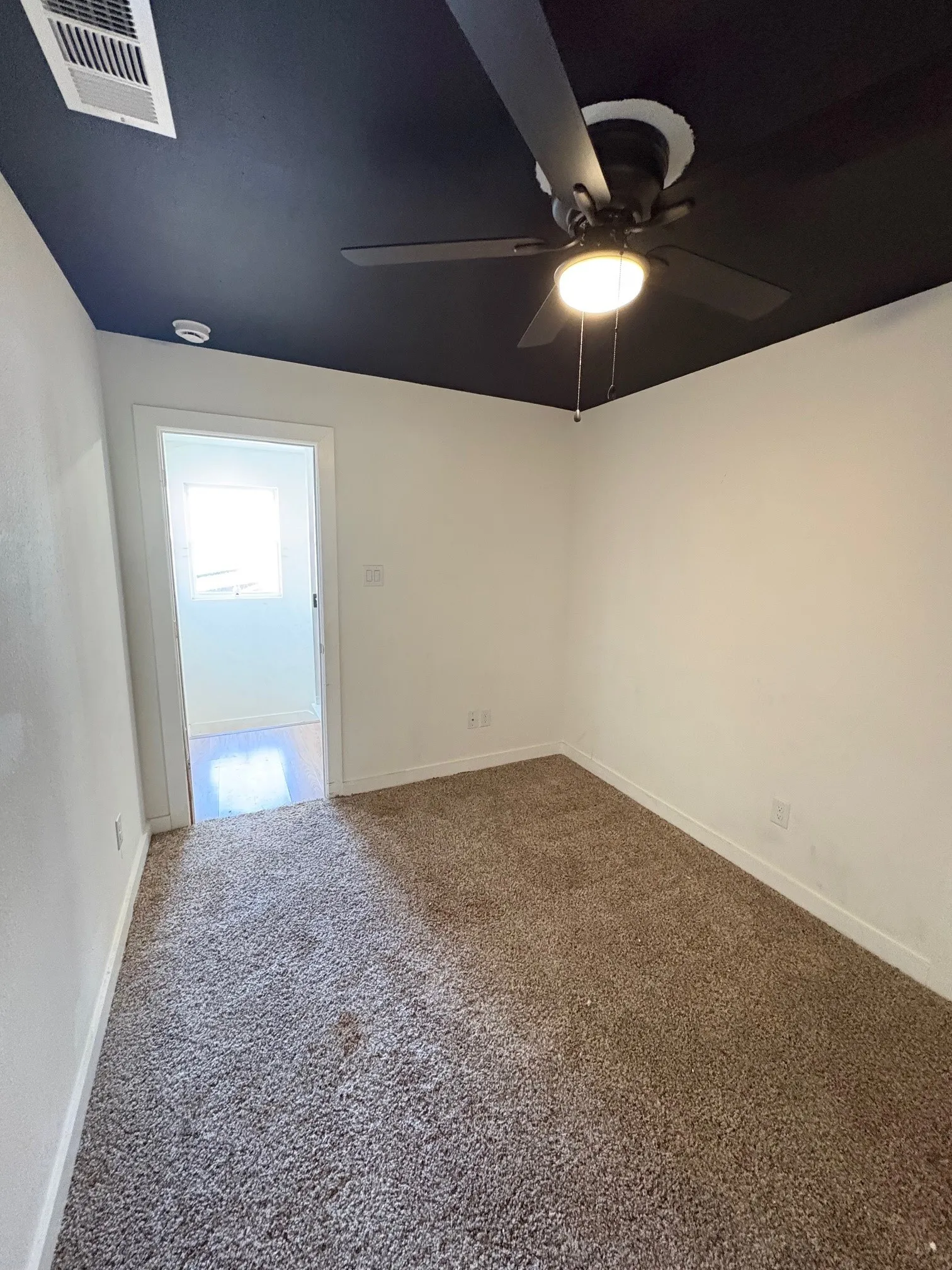 Bedroom two located upstairs. Ceiling fan.