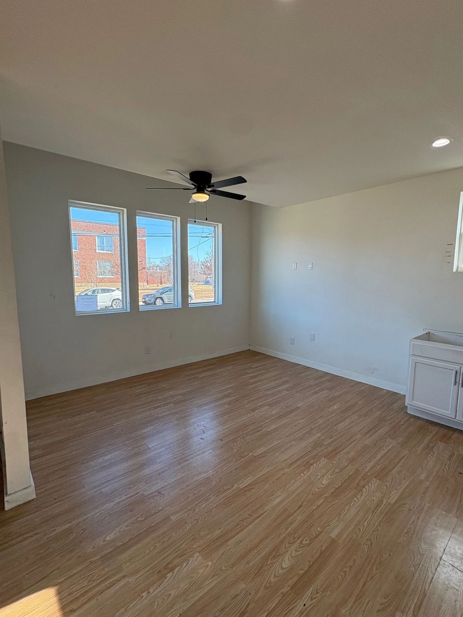 Living area is open to kitchen and dining area.  Ceiling fan.