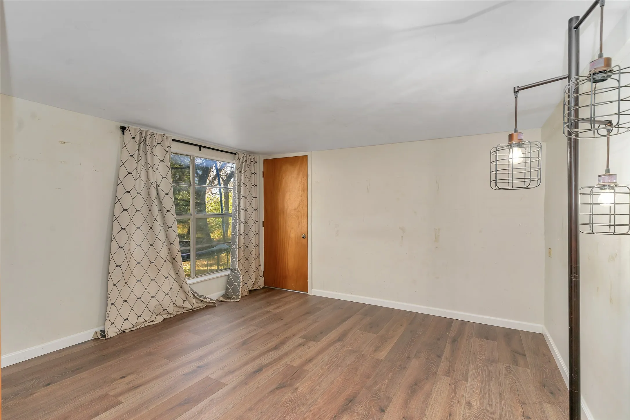 Empty room with wood finished floors and baseboards