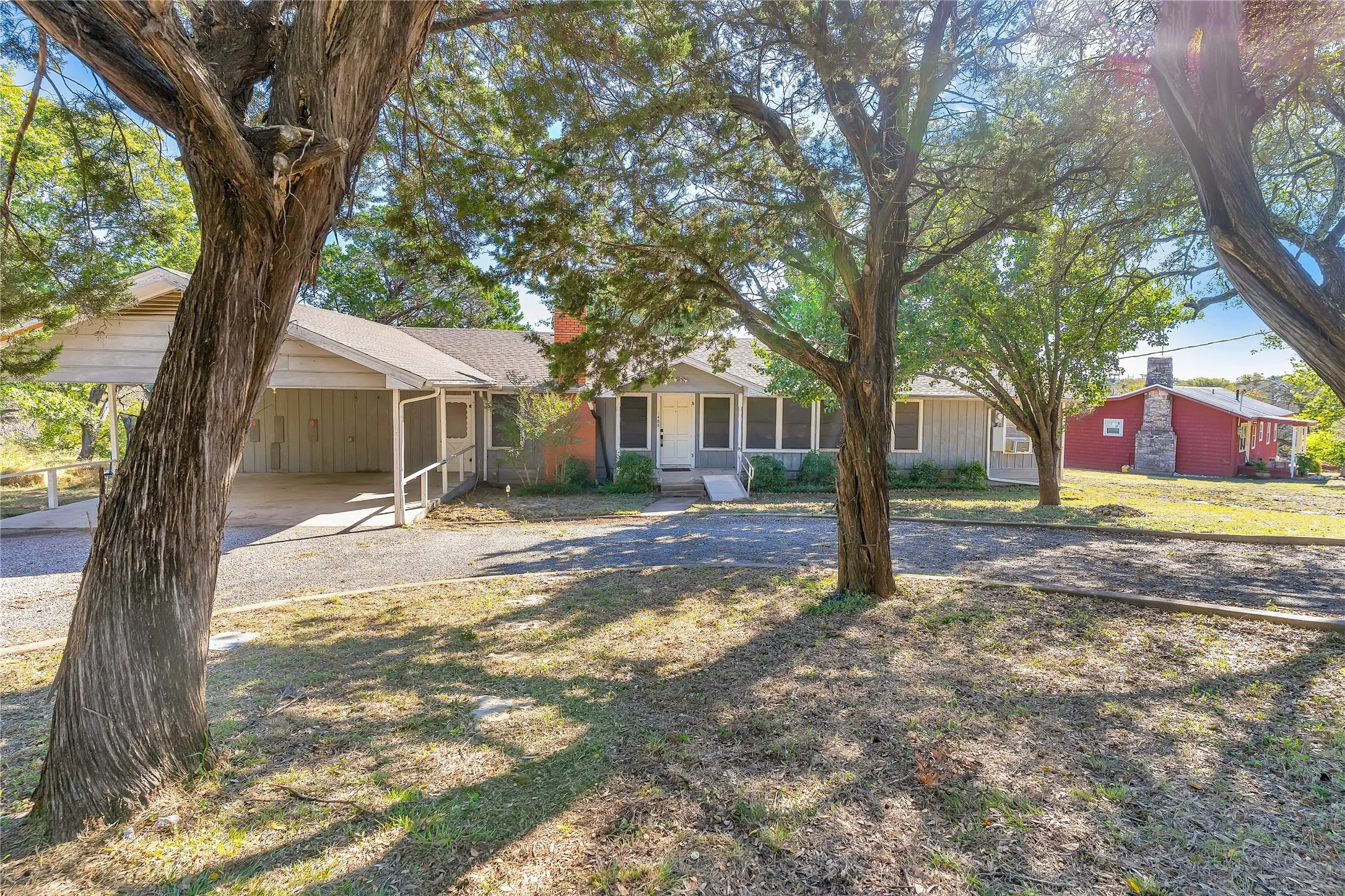 View of front of house featuring driveway, a front yard, and a chimney