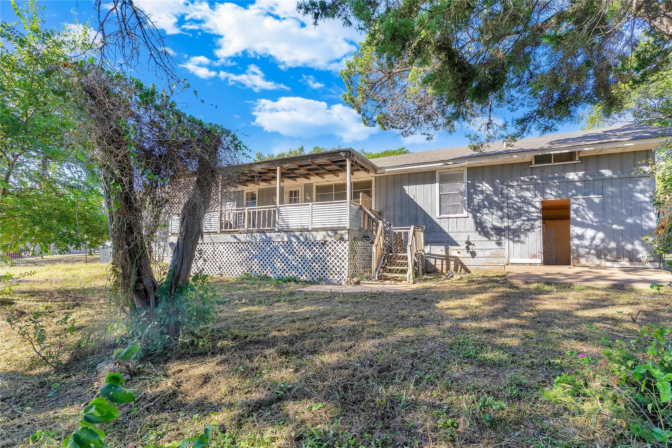 Rear view of property featuring a deck and stairs