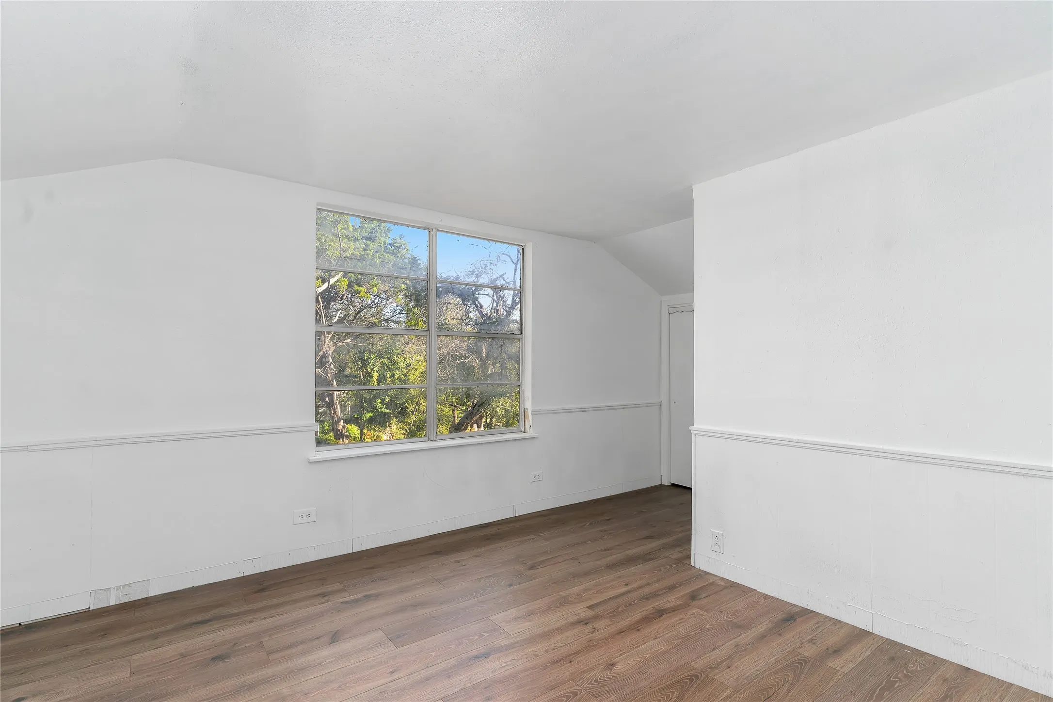 Bonus room featuring vaulted ceiling and wood finished floors