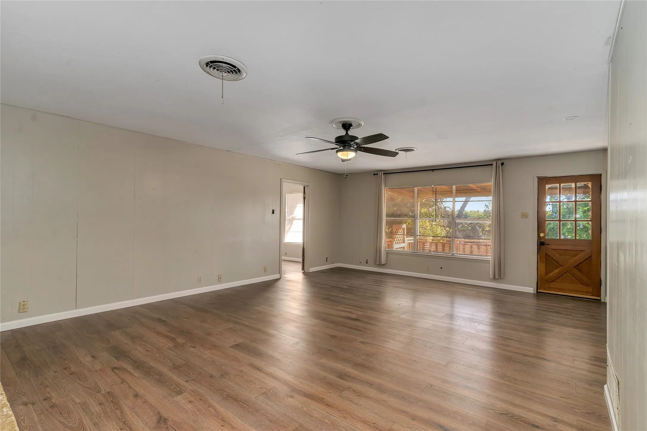 Spare room with wood finished floors and ceiling fan